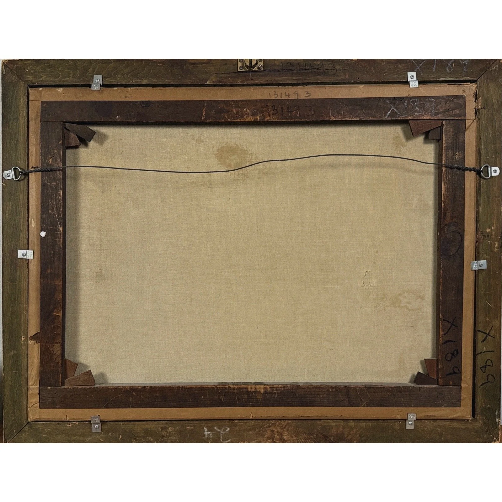 Verso view of the painting revealing the tear visible from the back of the canvas