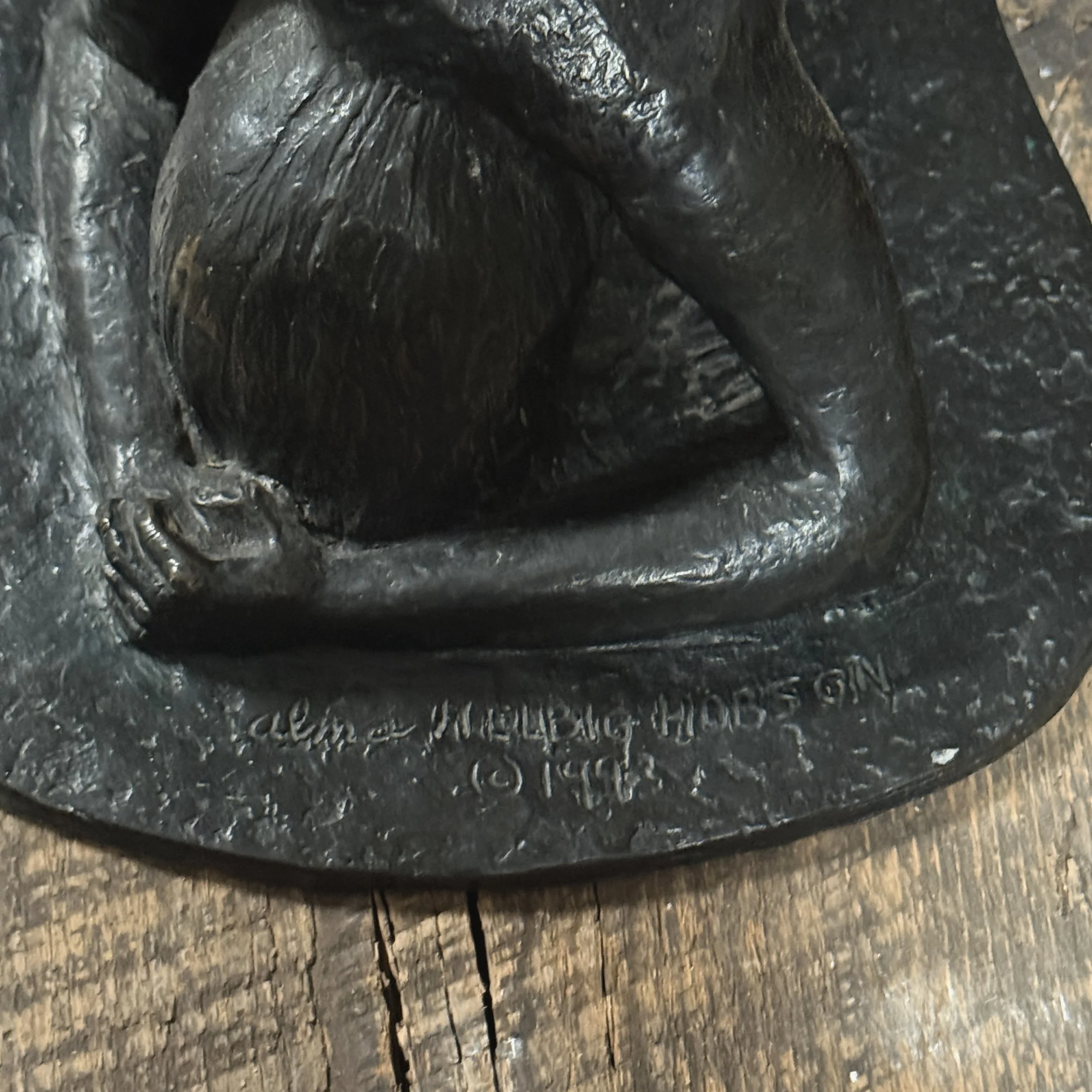 Close-up of Alma Hobson signature on upper border of sculpture