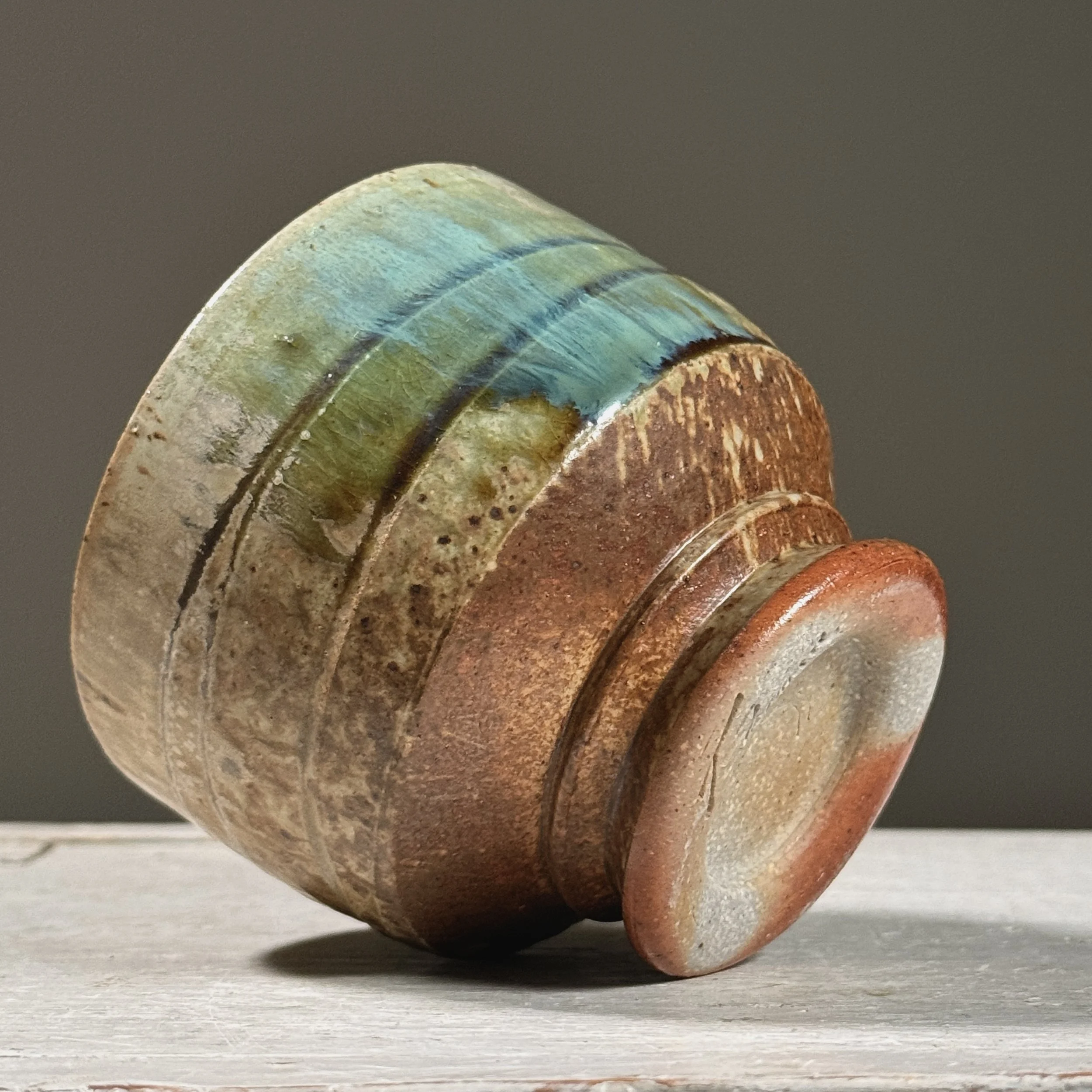 Angle emphasizing the interplay of ash and turquoise glazes.