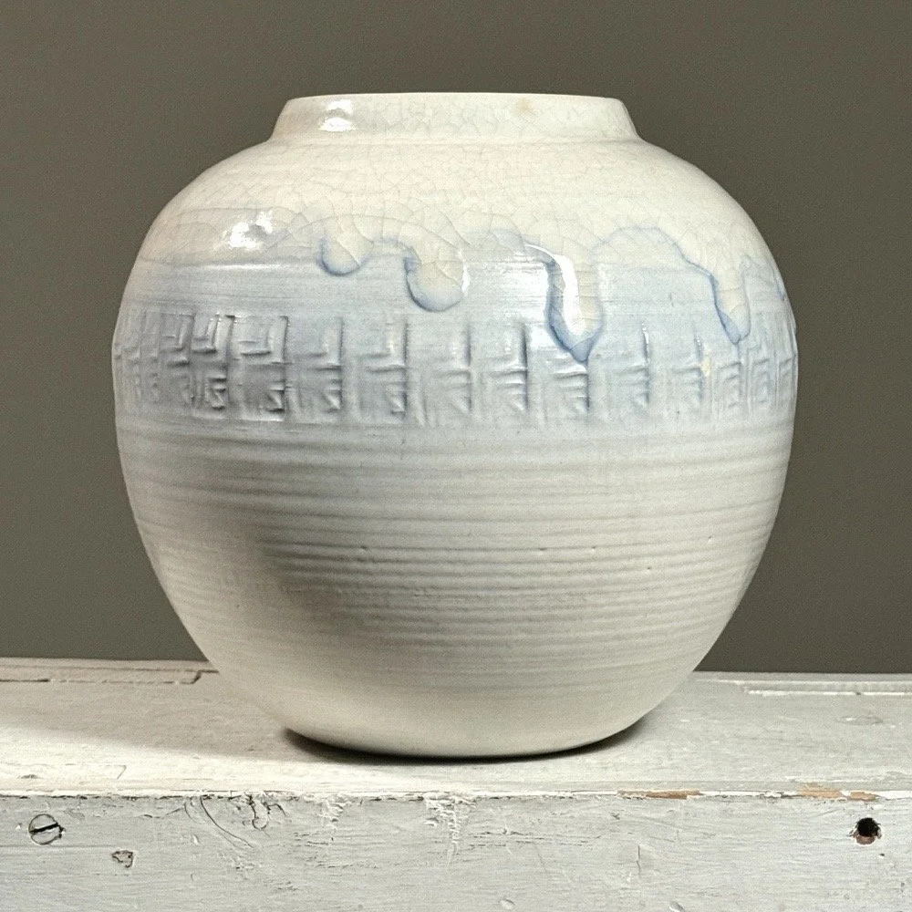 Front view of a vintage Japanese white crackle glaze ceramic vessel.