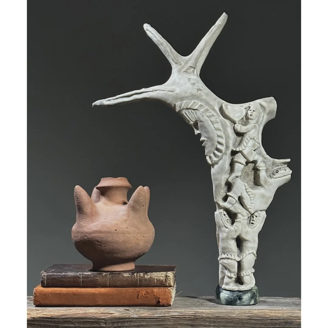 Full view of a vintage Inuit folk art antler sculpture with figures and moon with books.