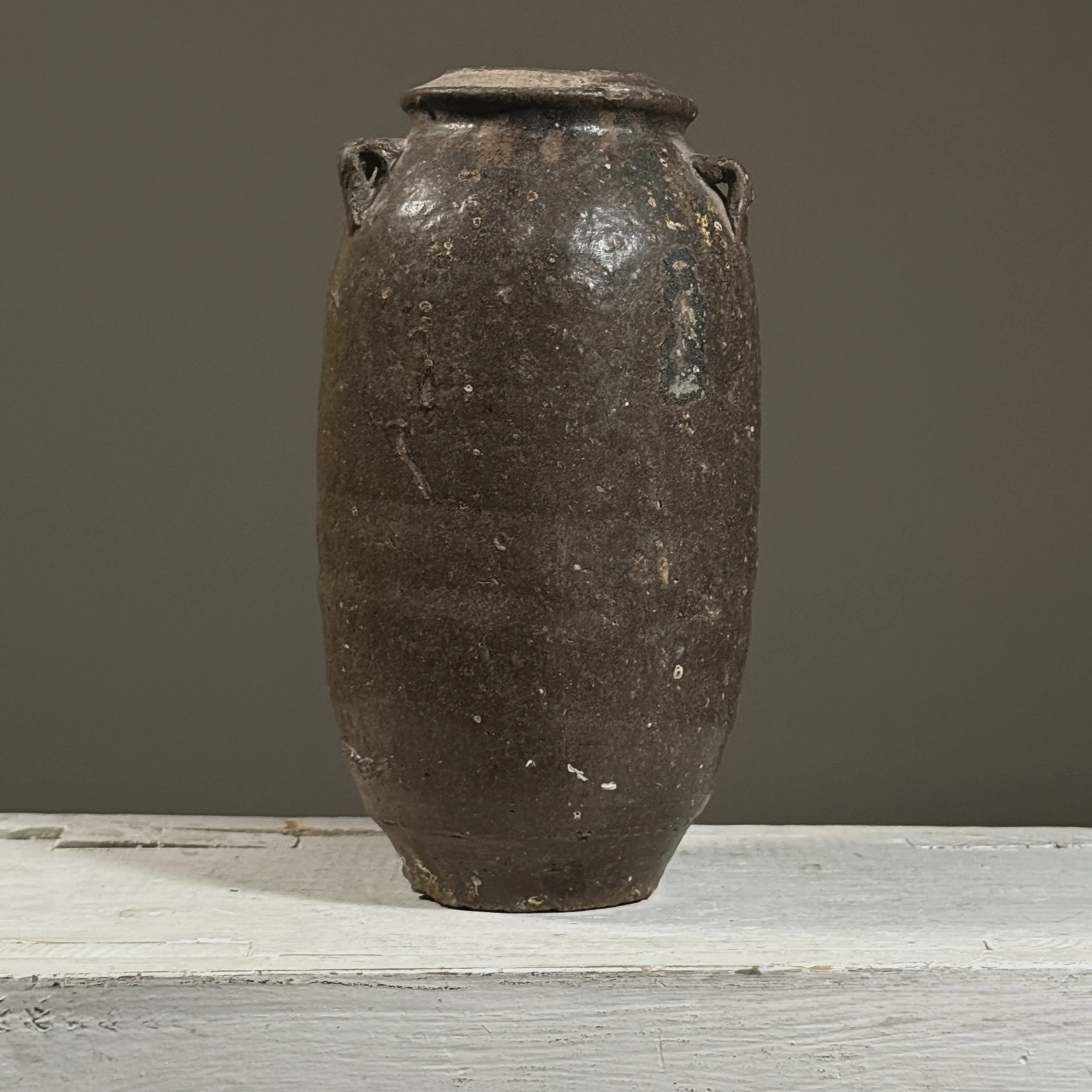 Full view of a 17th-century Vietnamese brown-glazed stoneware jar with lug handles.