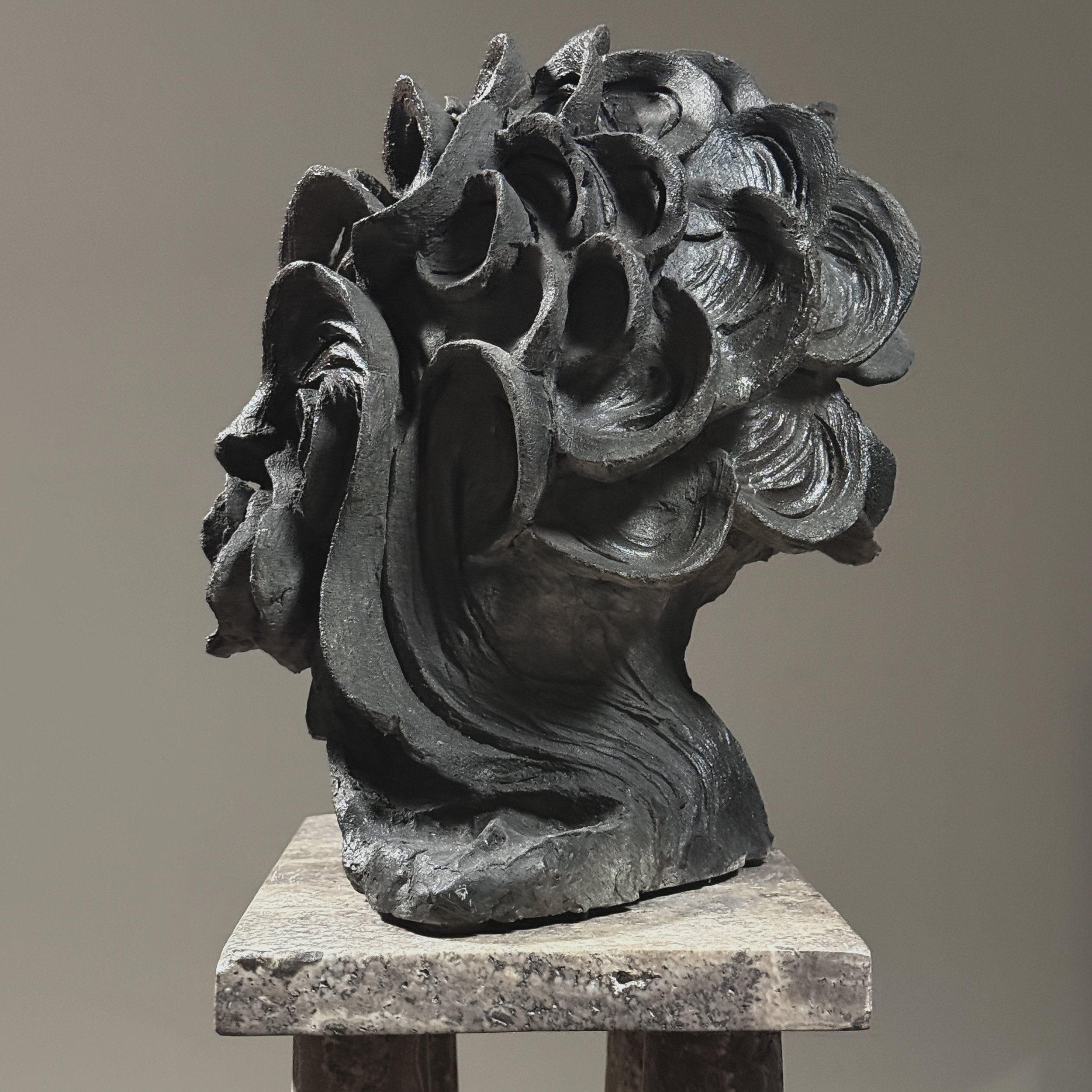 Side profile. 9.25 inch depth. Undulating waves form the portrait.