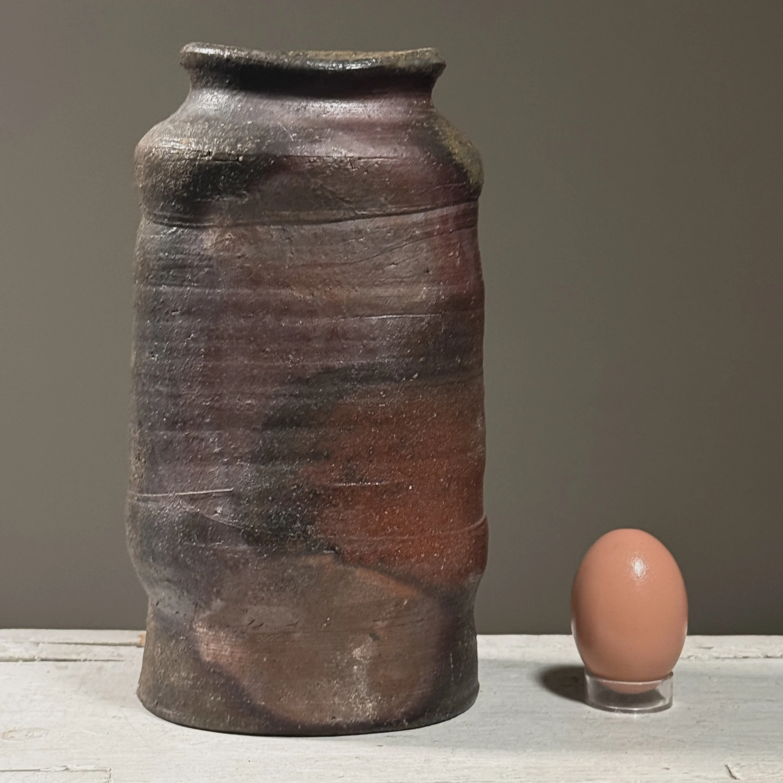 Vintage Japanese Bizen ware wood fired stoneware vessel with egg for size reference.