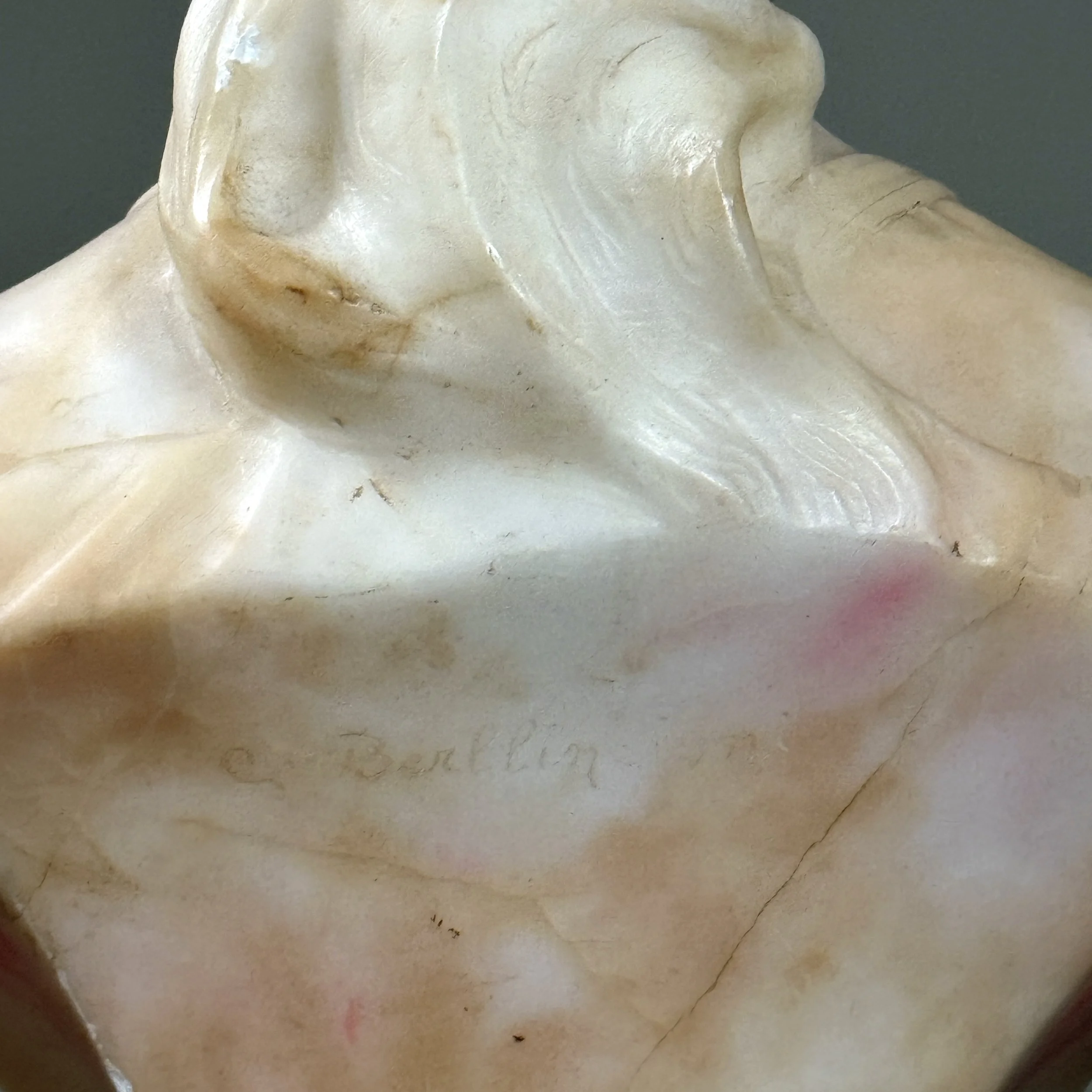 Close-up of the sculptor's signature inscribed on the reverse of the bust.