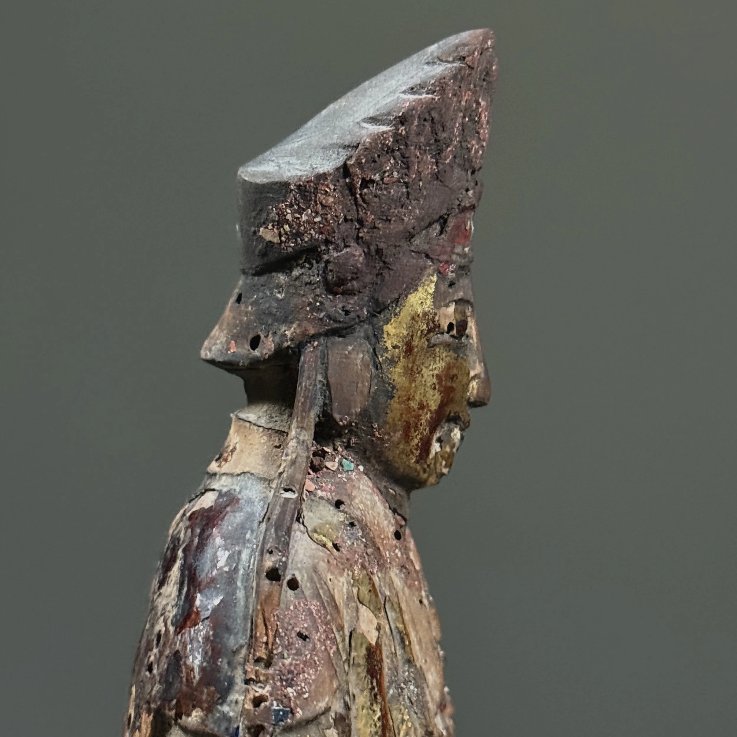 Close-up of gilt loss and exposed wood grain.