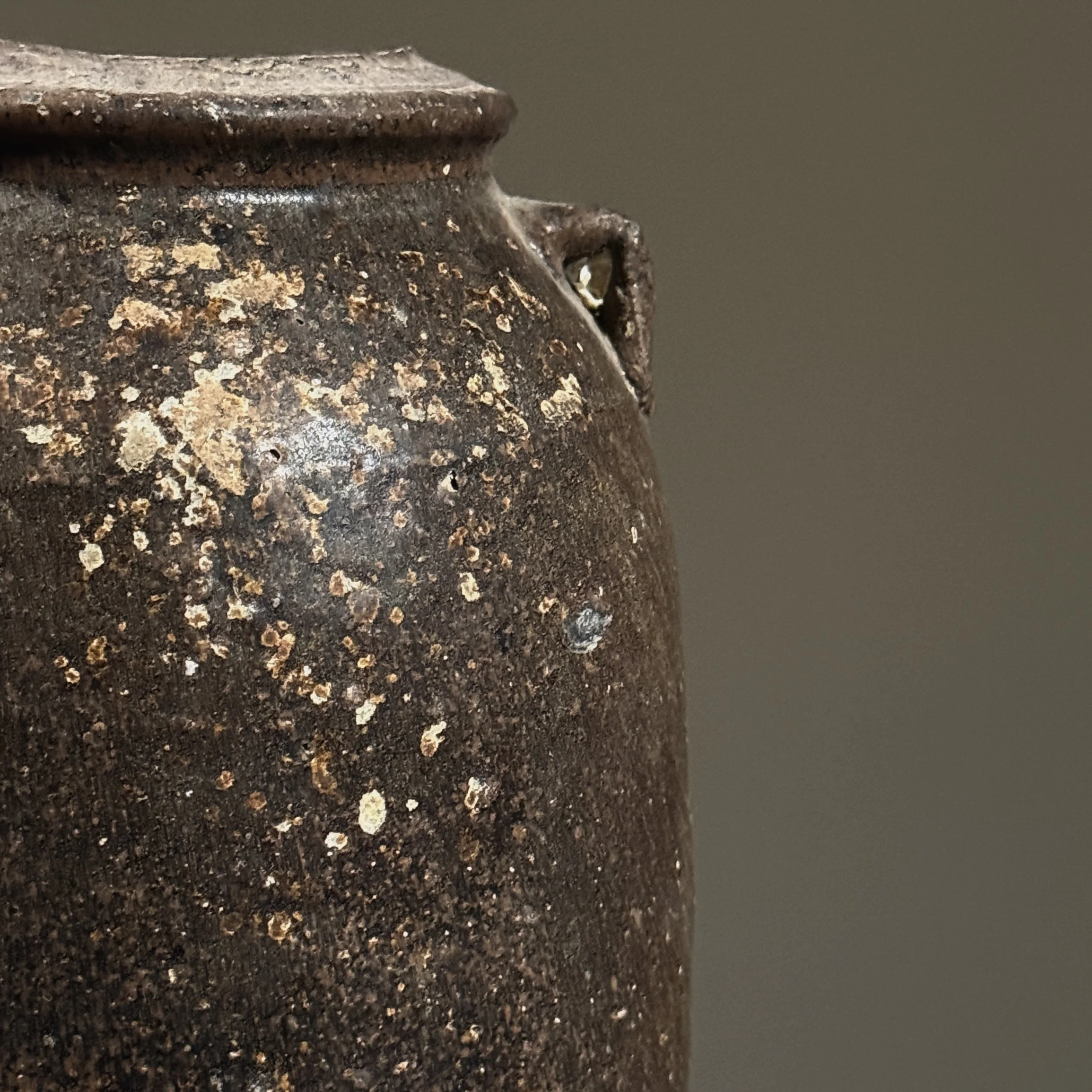 Detail of the brown glaze surface and subtle variations in color and texture.