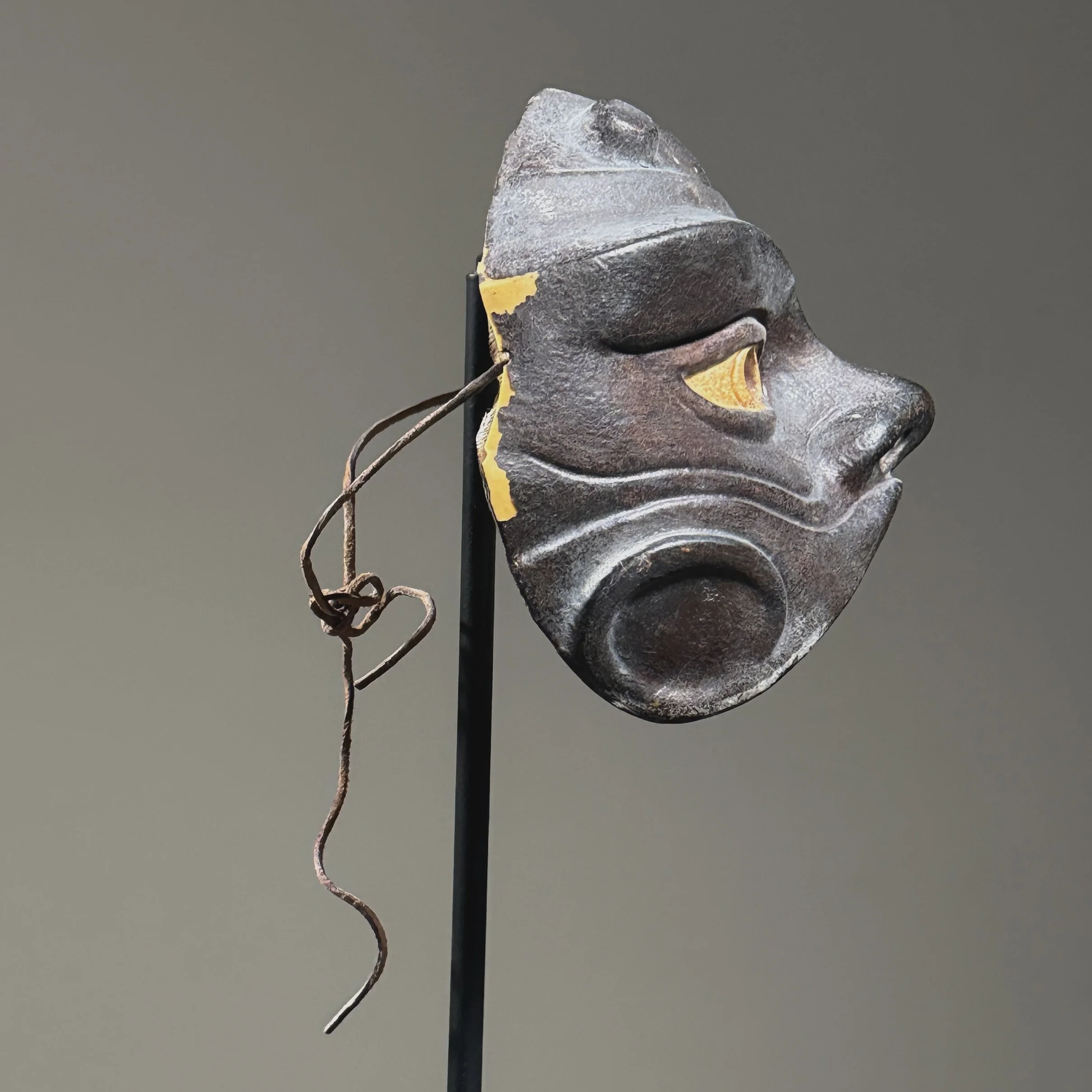 Profile view showing loss along right lateral edge of leather harlequin mask
