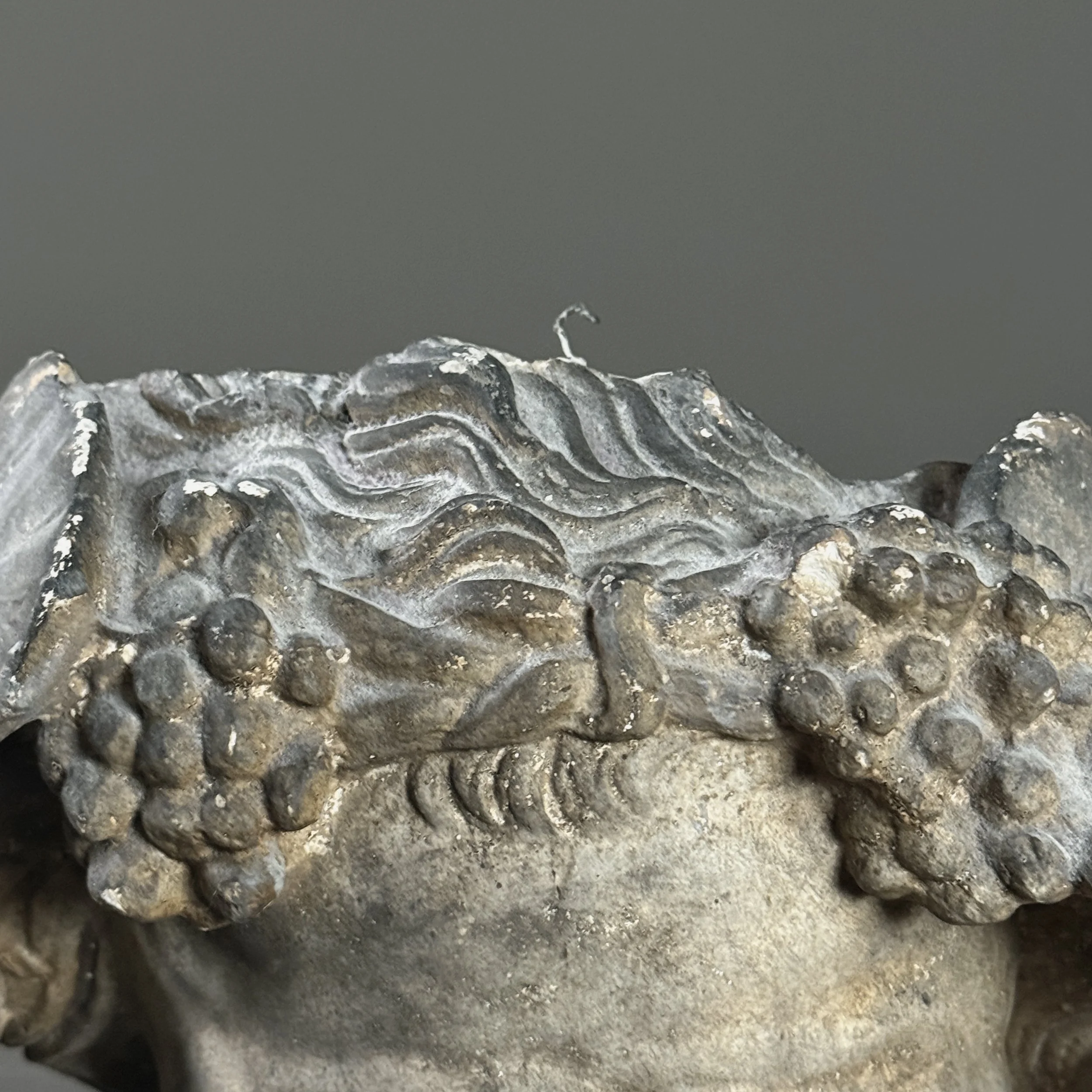 Close-up showing the textural quality of the cast plaster and minor chips.