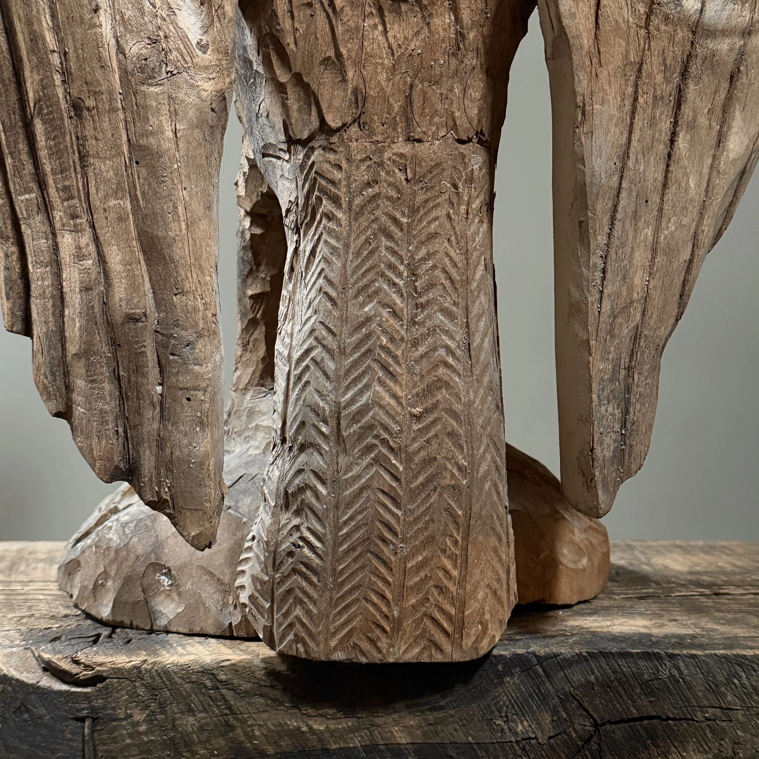 Monumental folk art bird carving wing detail