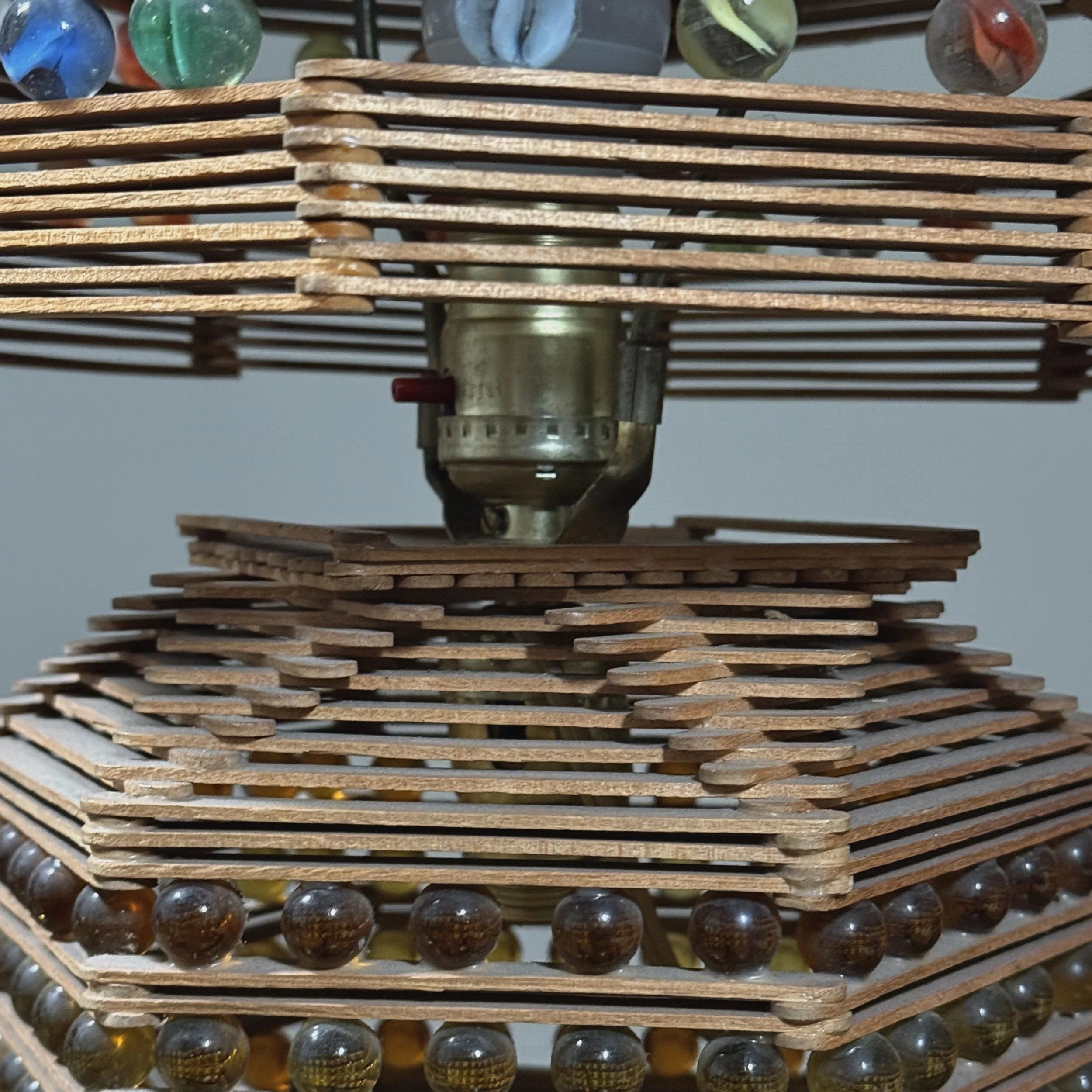 Close-up of the lamp's base, switch or pull chain, and rotating mechanism.