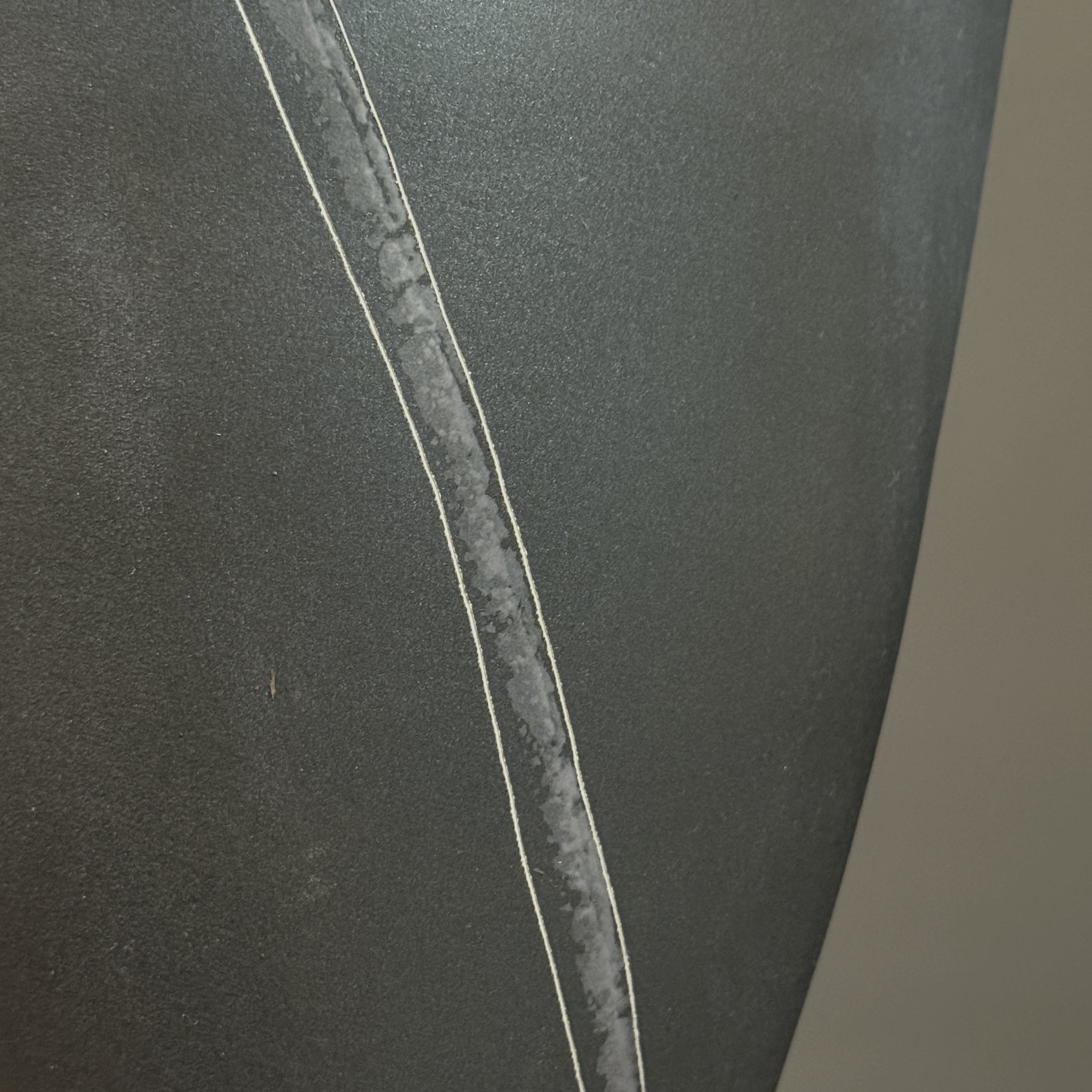 Line detailing close-up. Subtle incised lines along exterior.