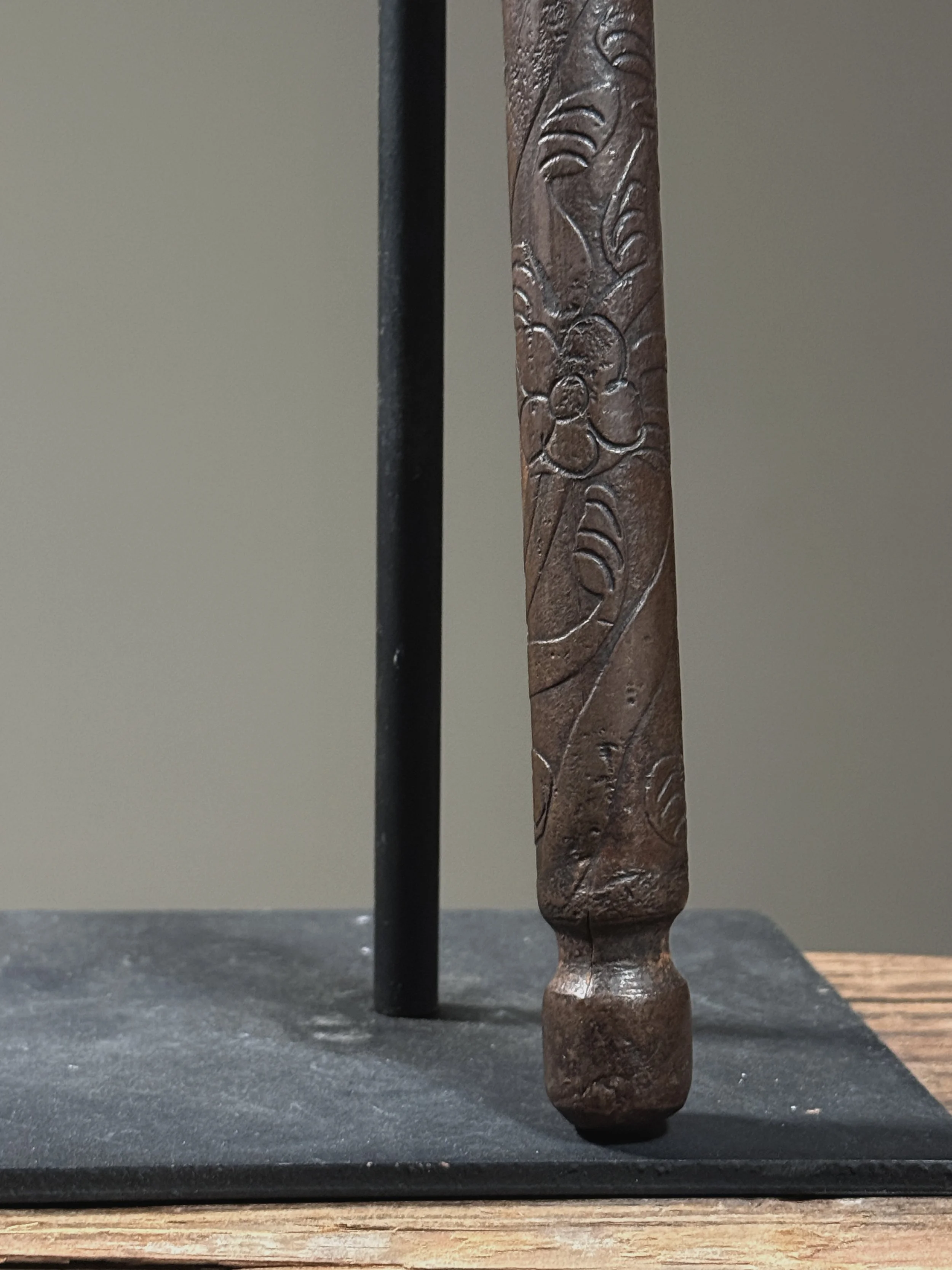 Surface detail showing oxidation pattern and minor abrasions on etched staff decoration