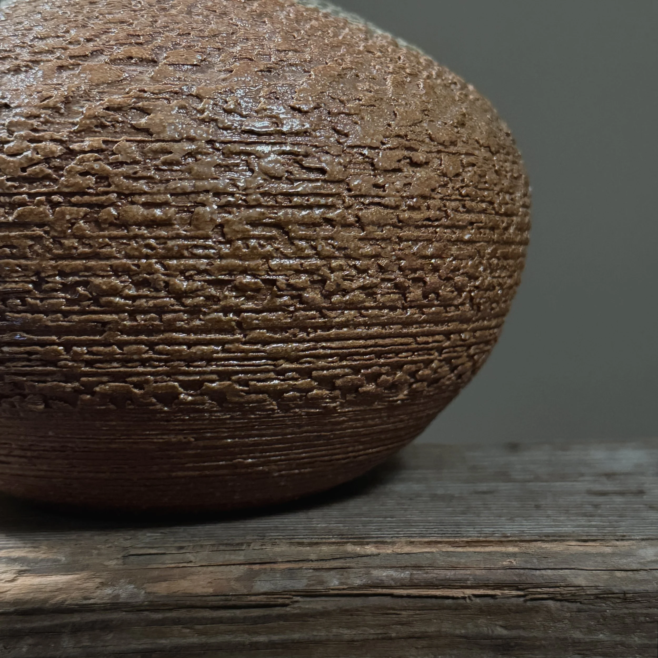 Close-up of the textured brown glaze surface.