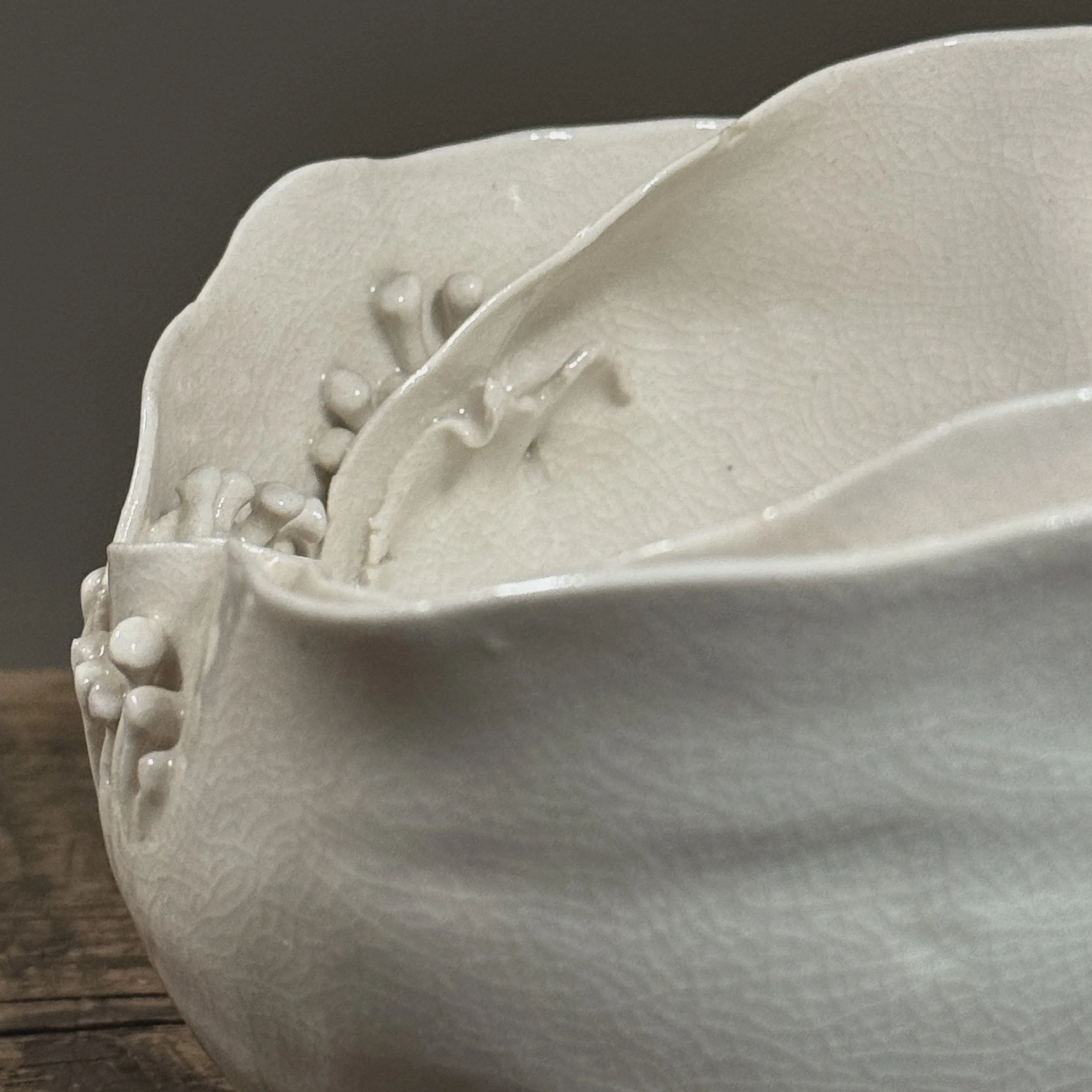 Crackle glaze studio pottery vessel with organic spore details