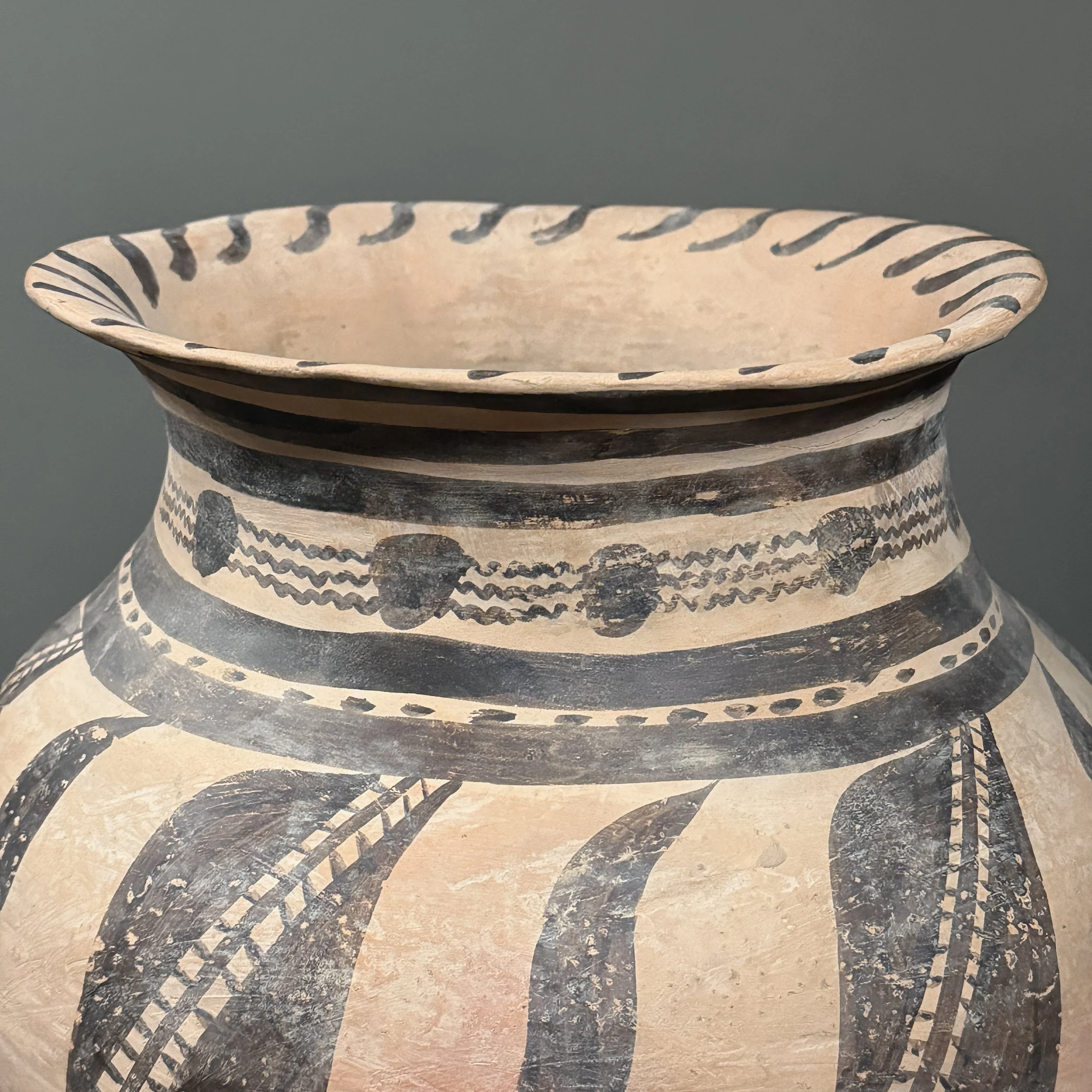 View of the vessel's flared rim and small age-related crack.