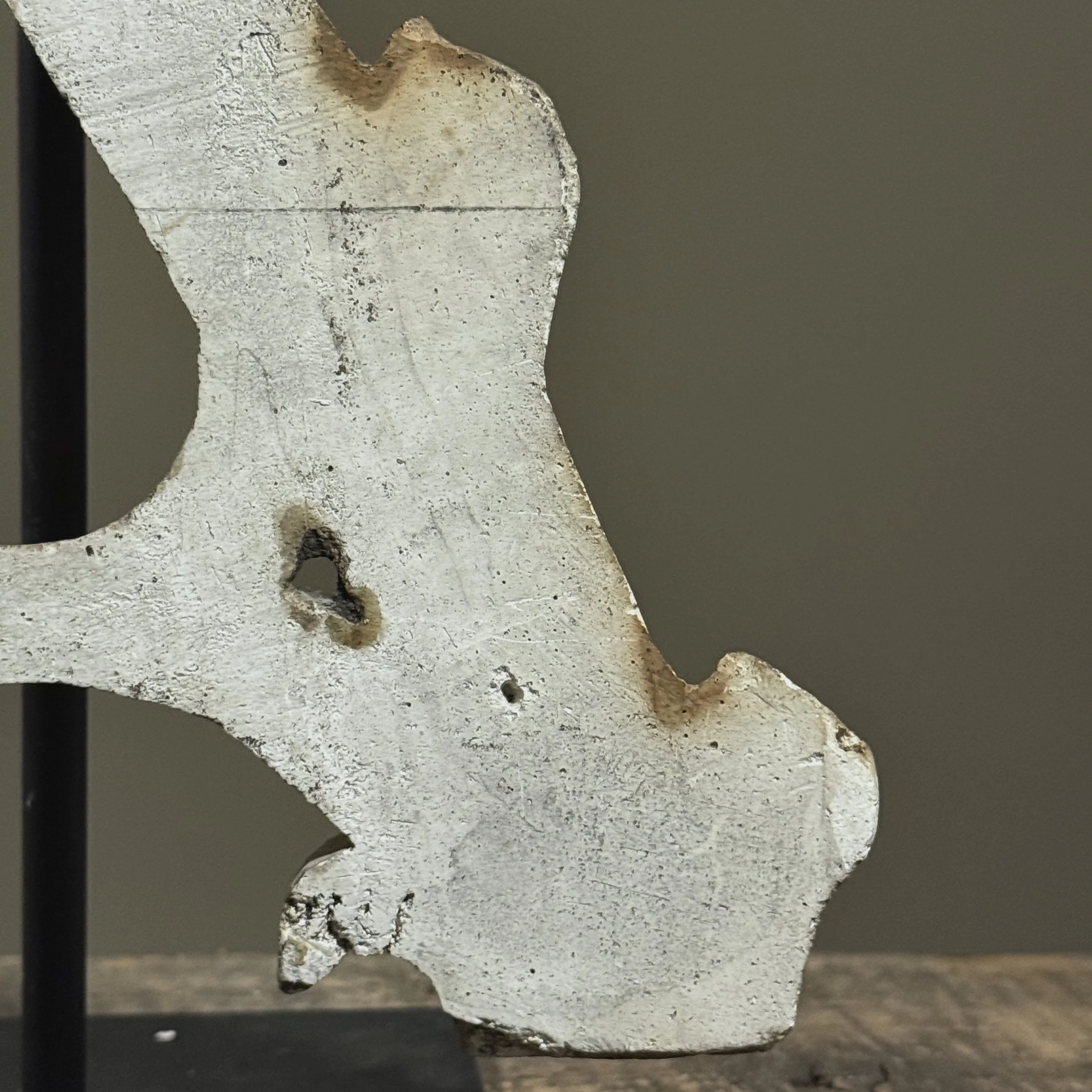 Textured plaster surface with iron support visible in back