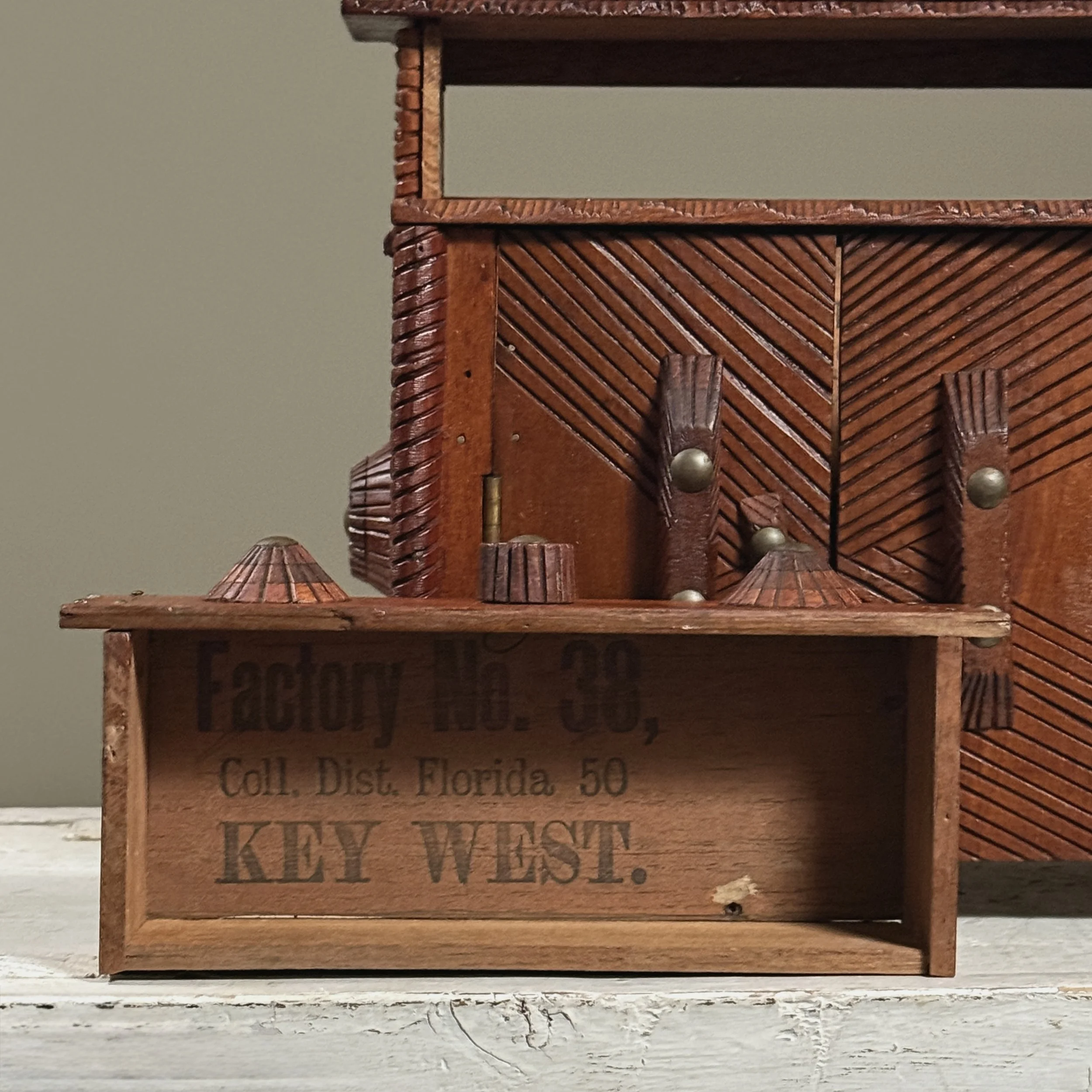 Close-up of drawer with three carved knob pulls