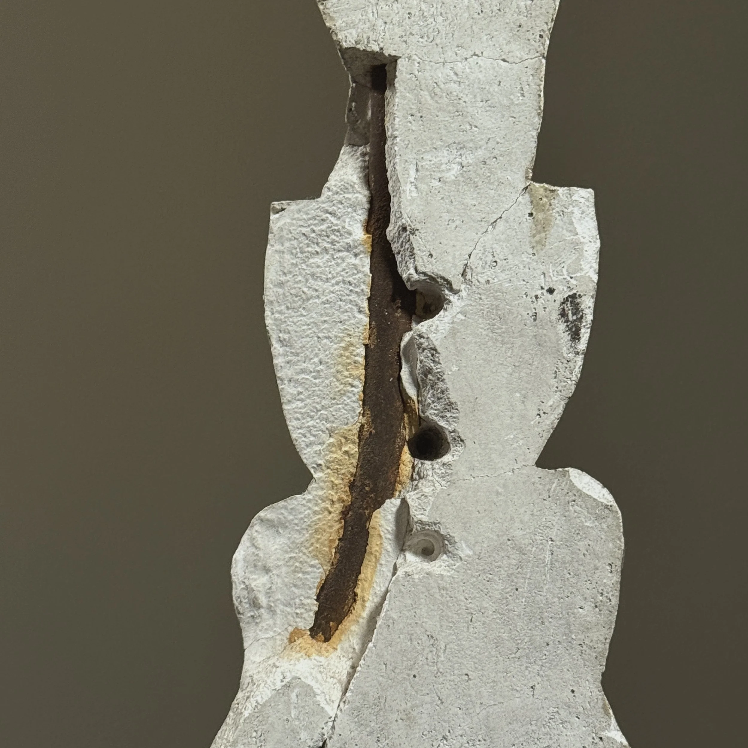 Textured plaster surface with iron support visible in back