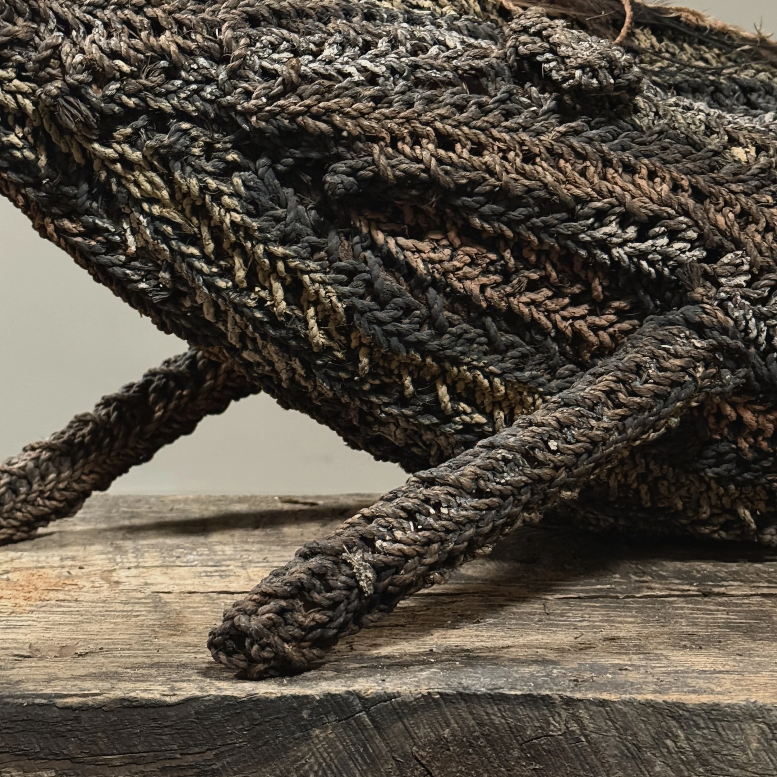 Detail of painted fiber and raffia. Decorative elements on bird body.