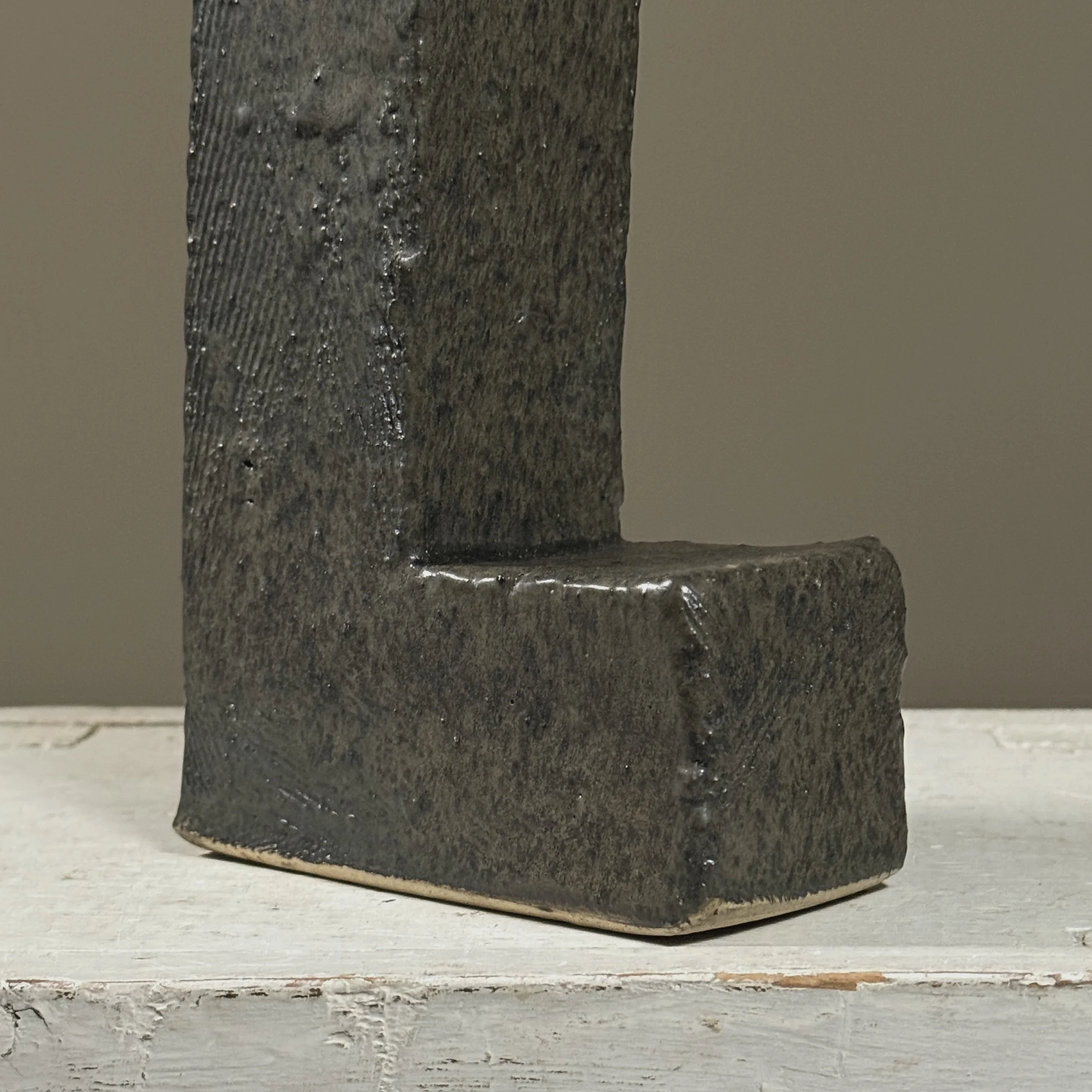 Detail of rough gray glaze surface on Brutalist vessel