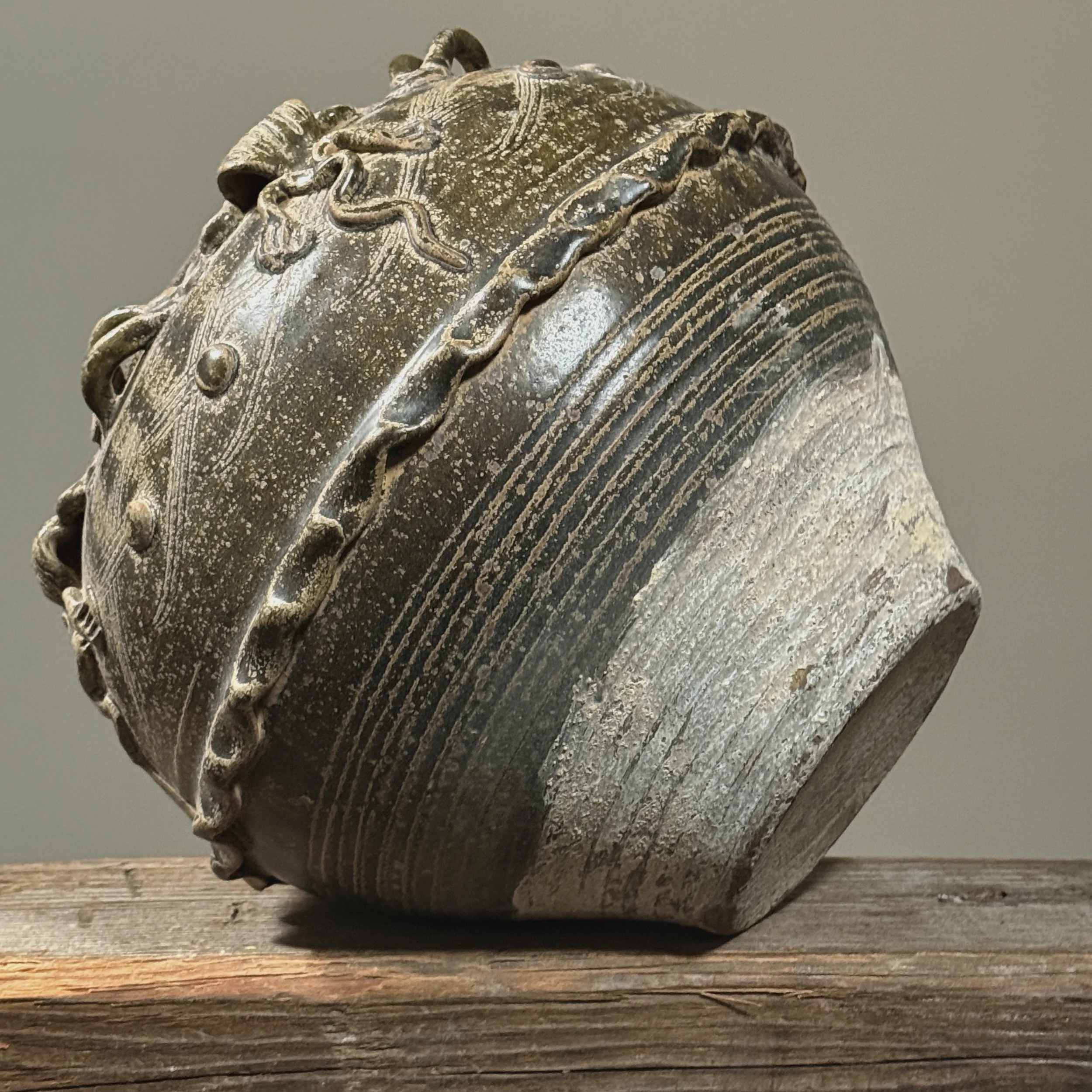 Front view of an antique 19th century Chinese brownish-green glazed stoneware vase.