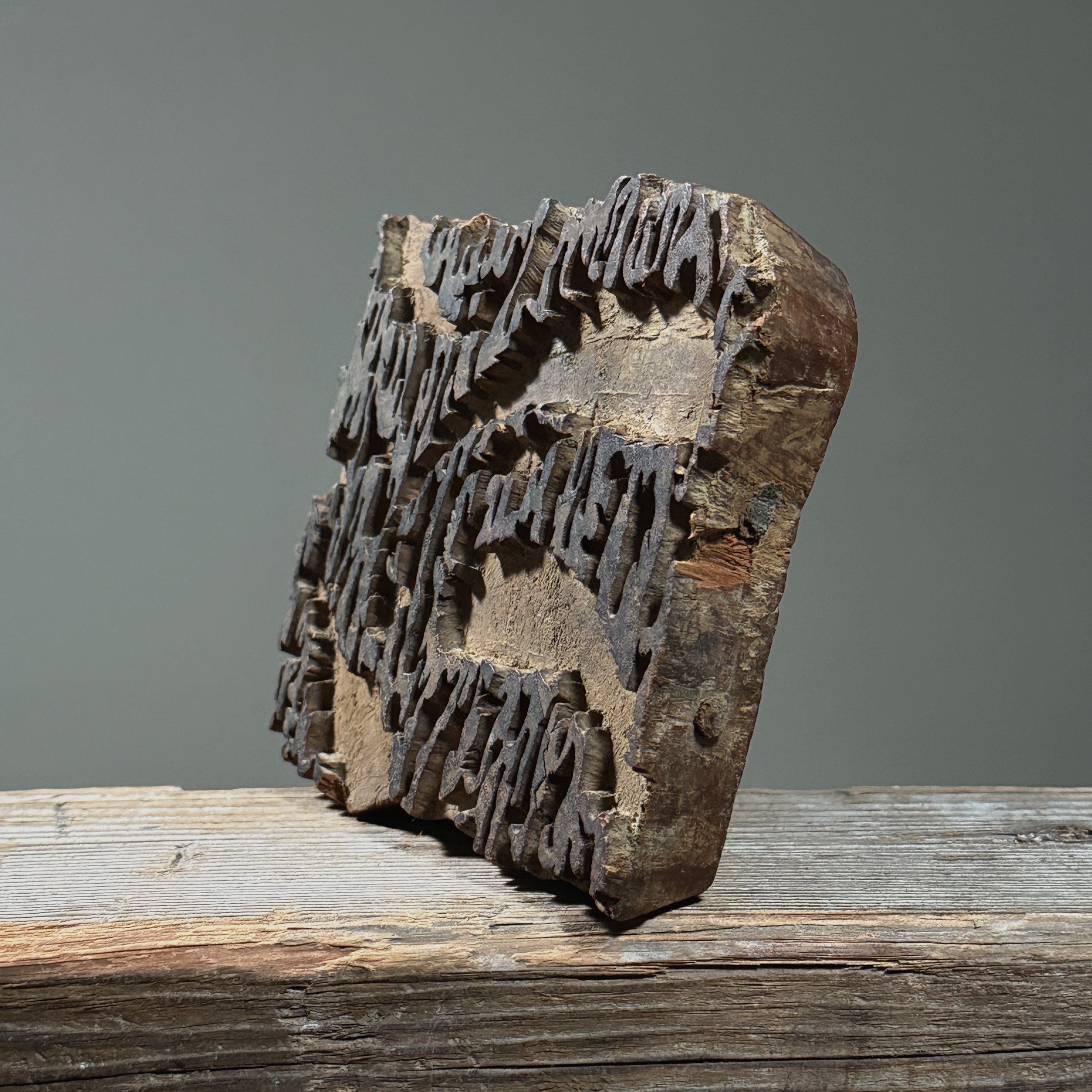 Close-up of the larger printing block showing carved relief design on the printing surface