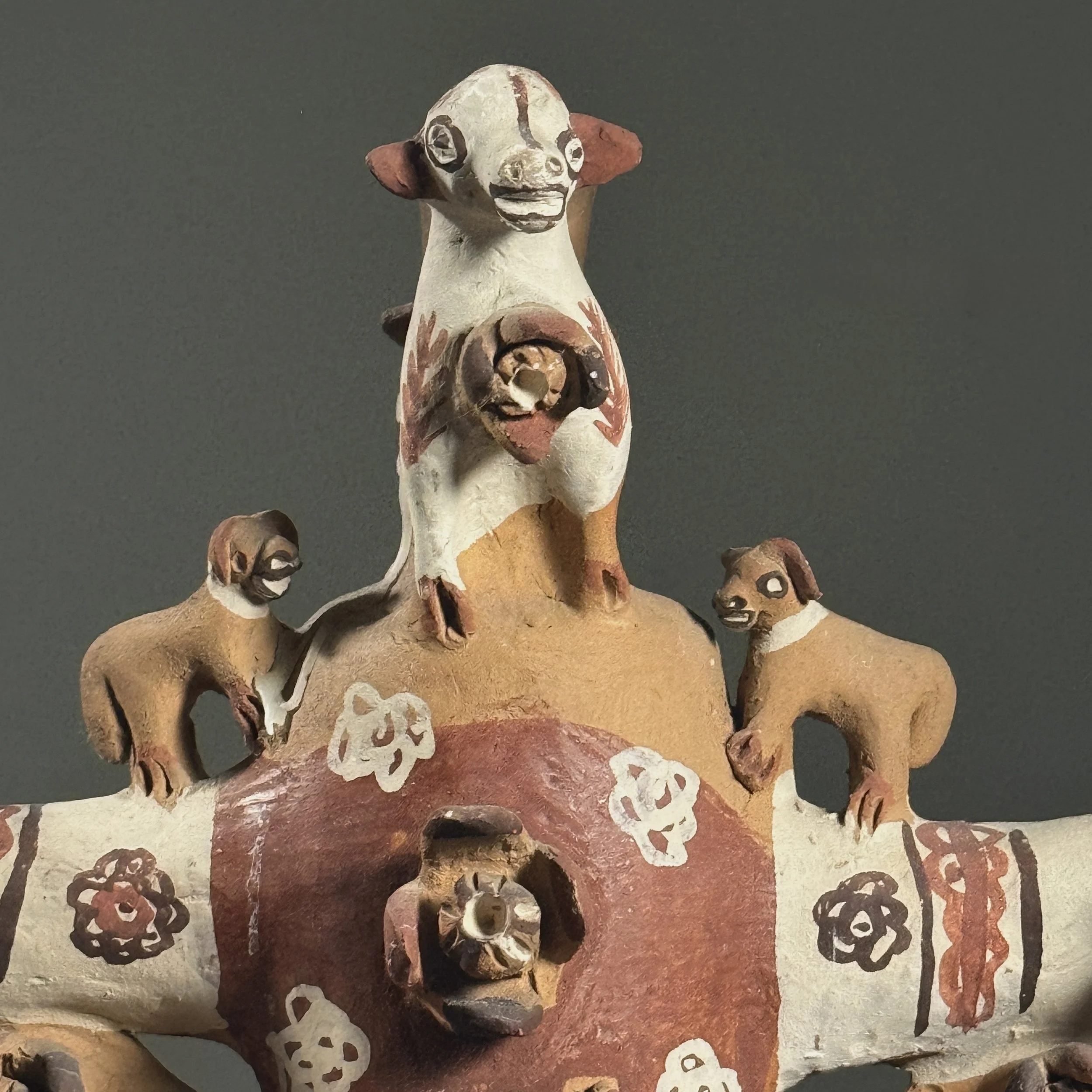 Detail of the top candle holder and surrounding figural decoration