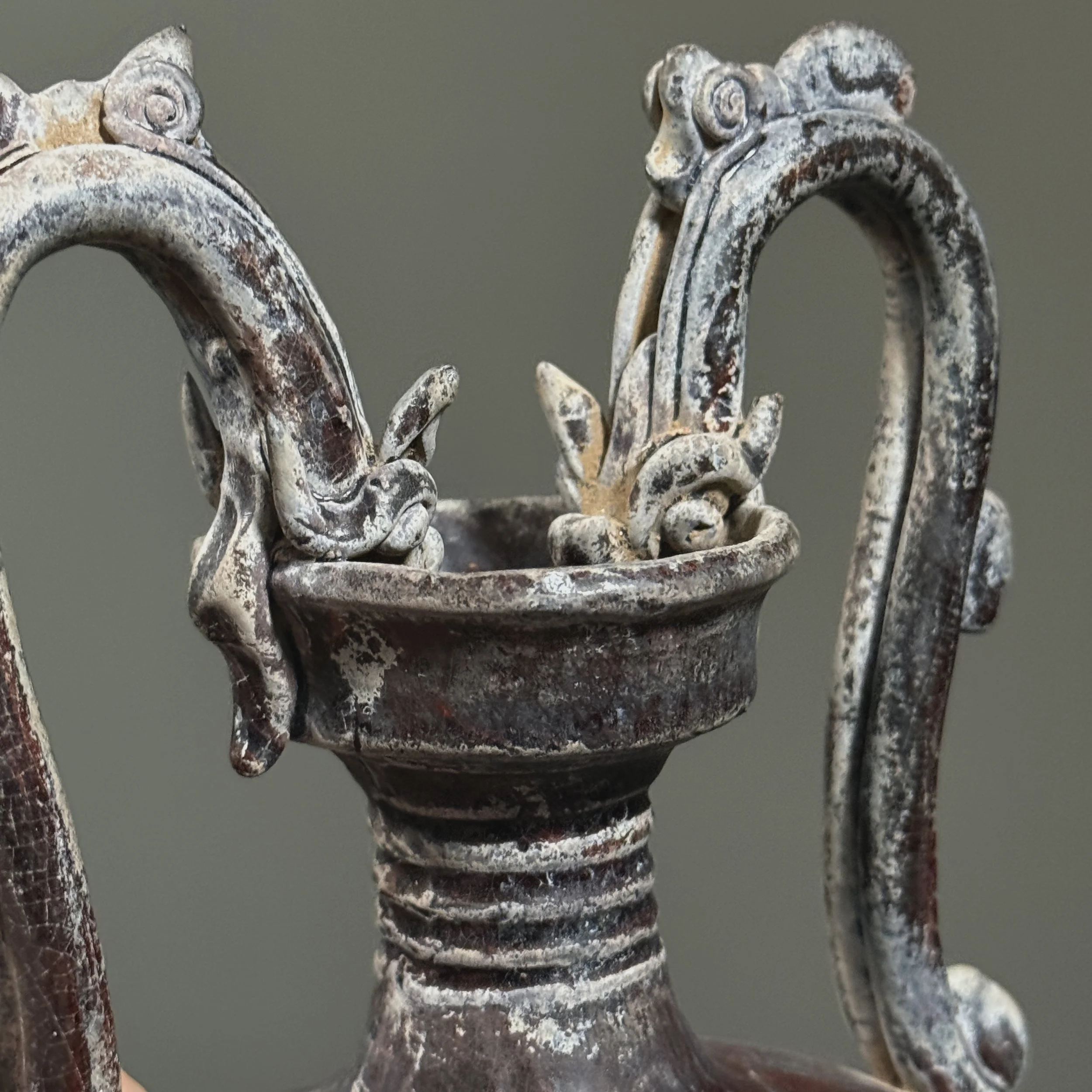 Close-up of dragon-head handles on Chinese vase