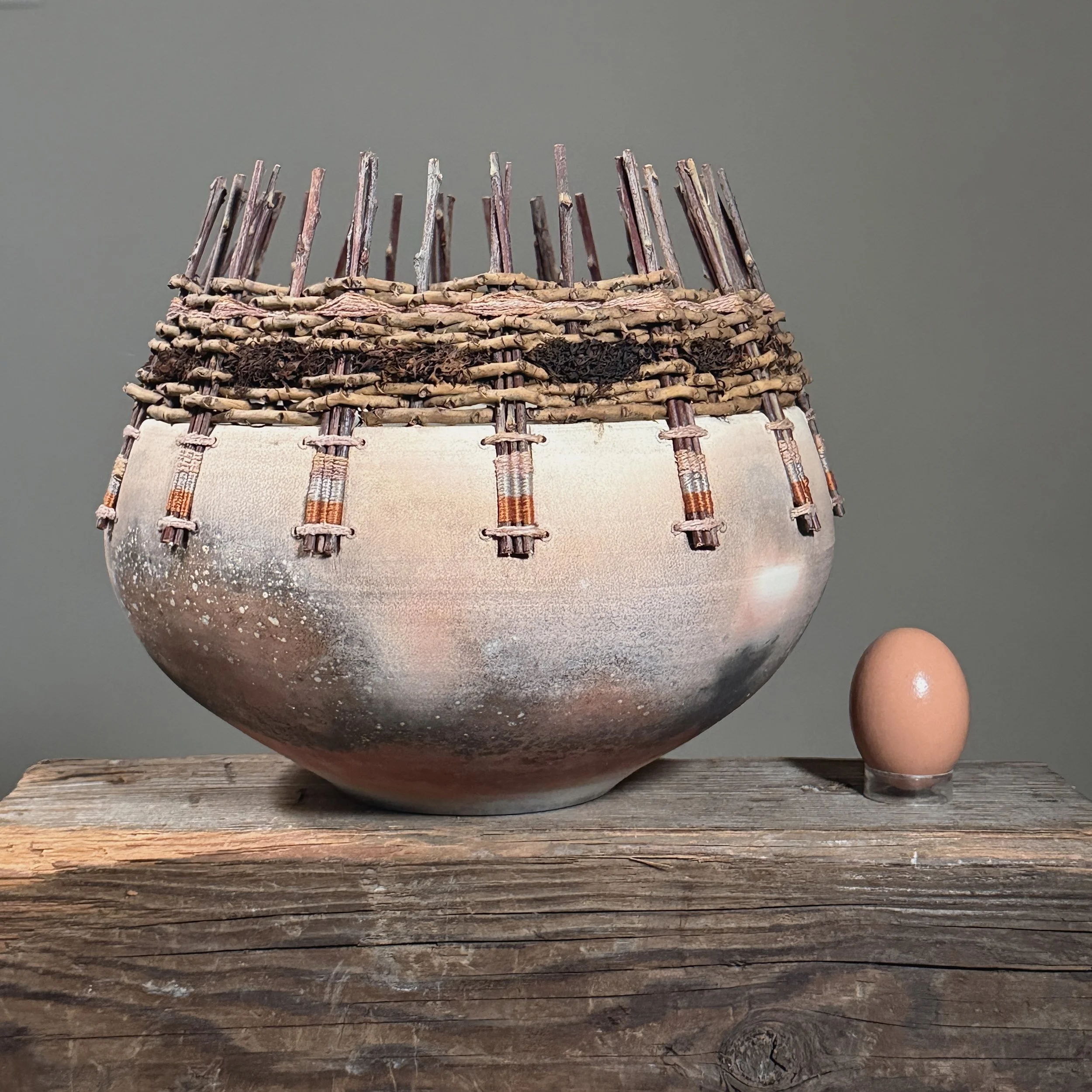 Vintage organic modern raku ceramic pot signed with an egg for size reference.