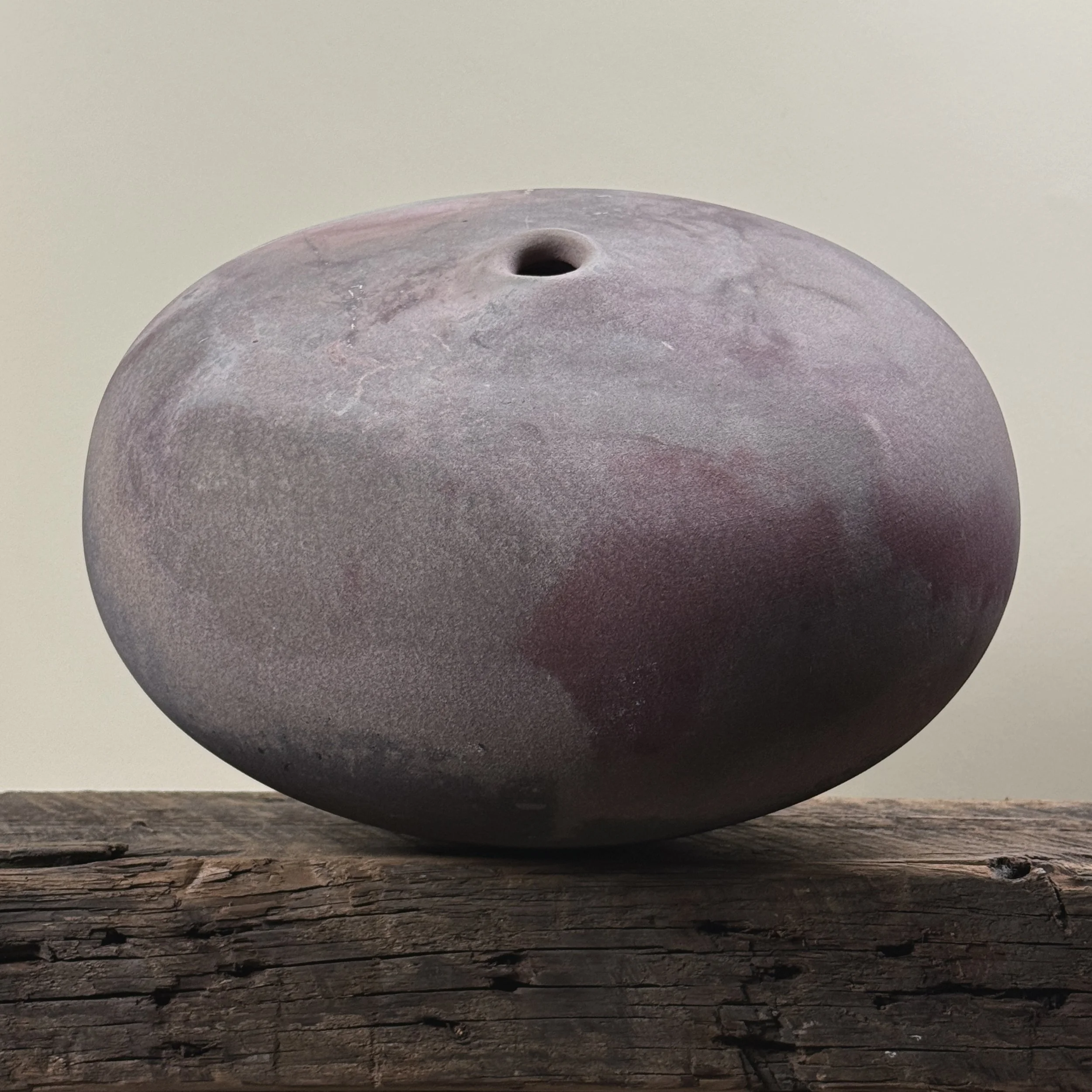 Jeffrey Zigulis large anagama fired seed pot vessel. Muted mauve and magenta hues. 12.5 inches diameter.