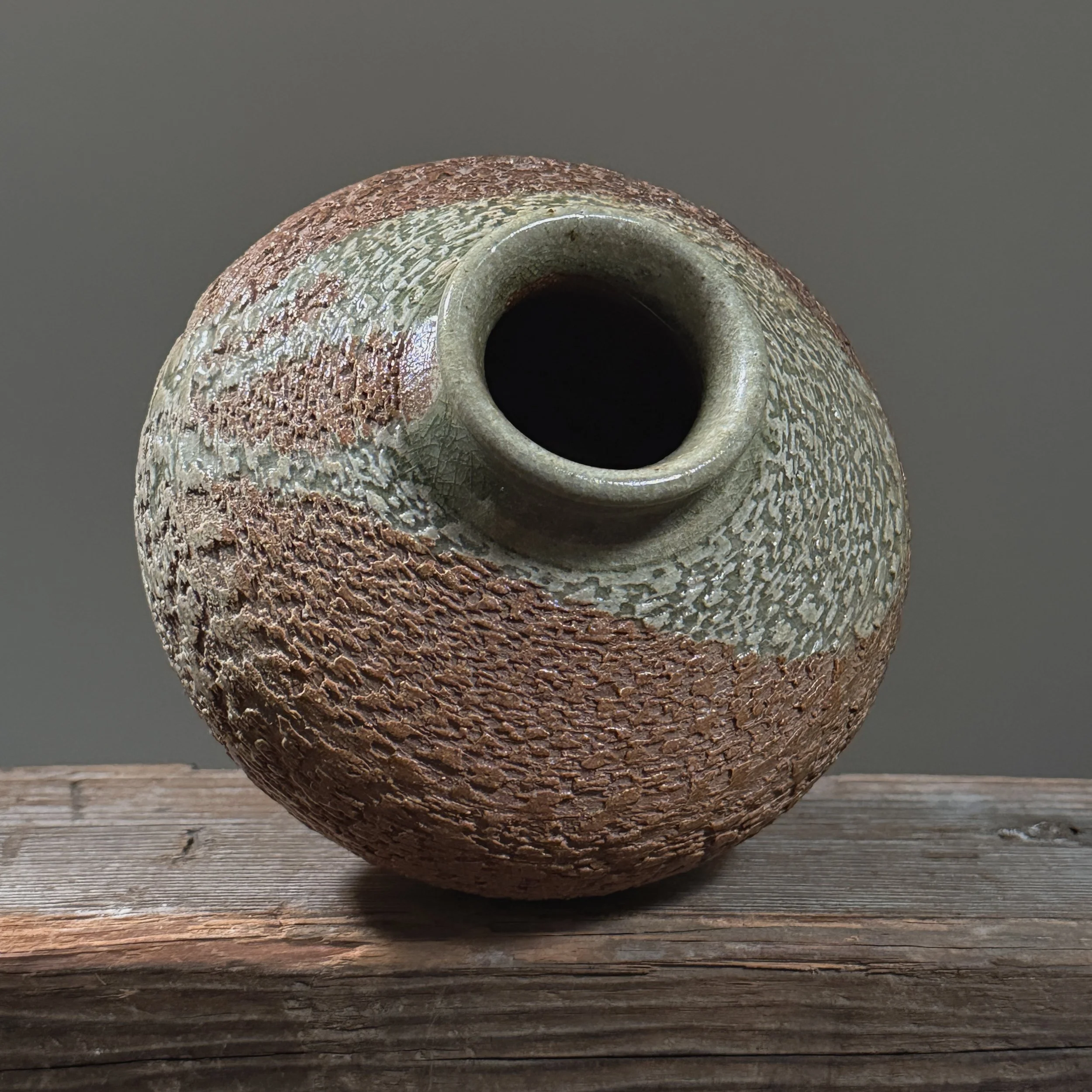 Top-down view into the vase showing the celadon glaze on the interior rim.