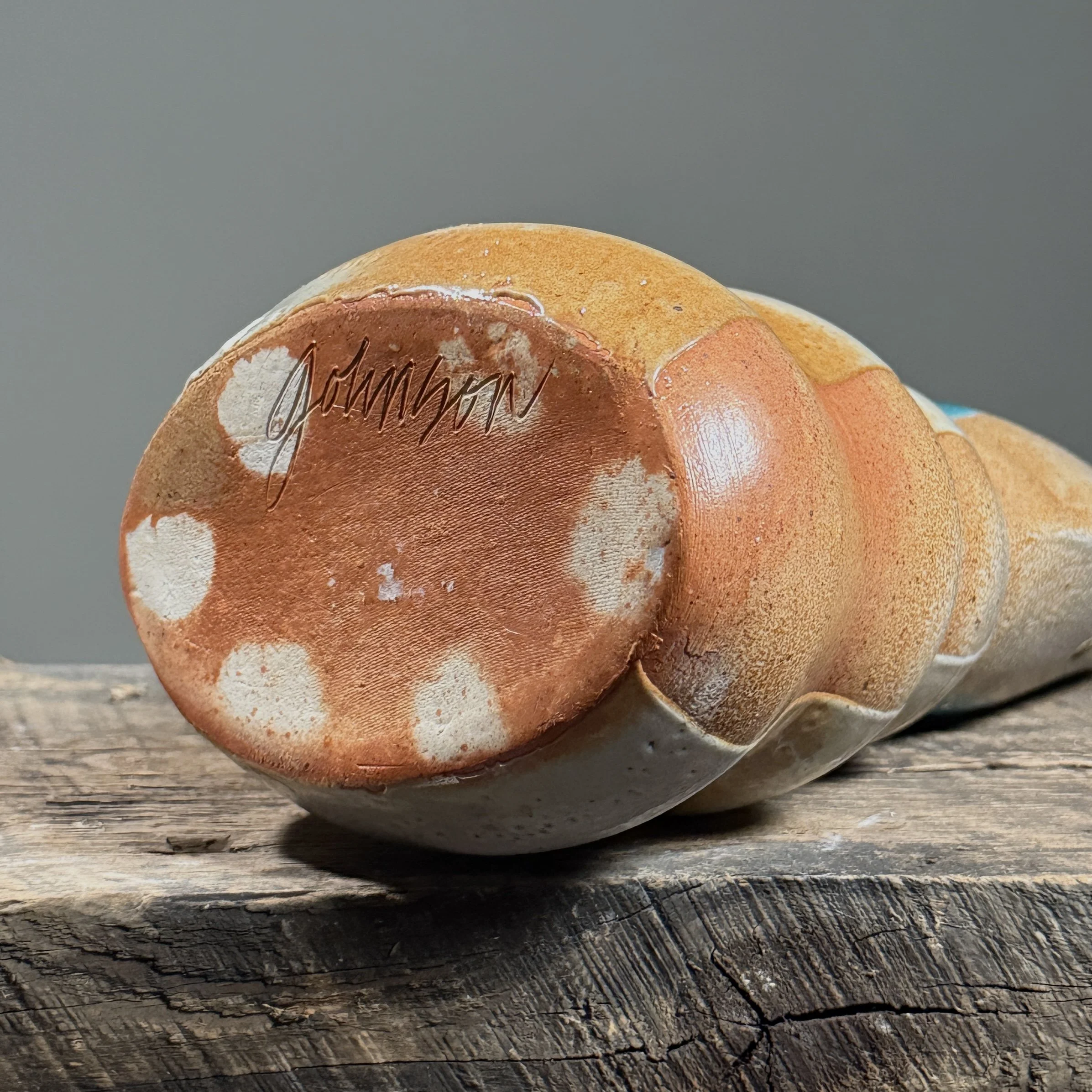 View of the base showing the artist's signature.