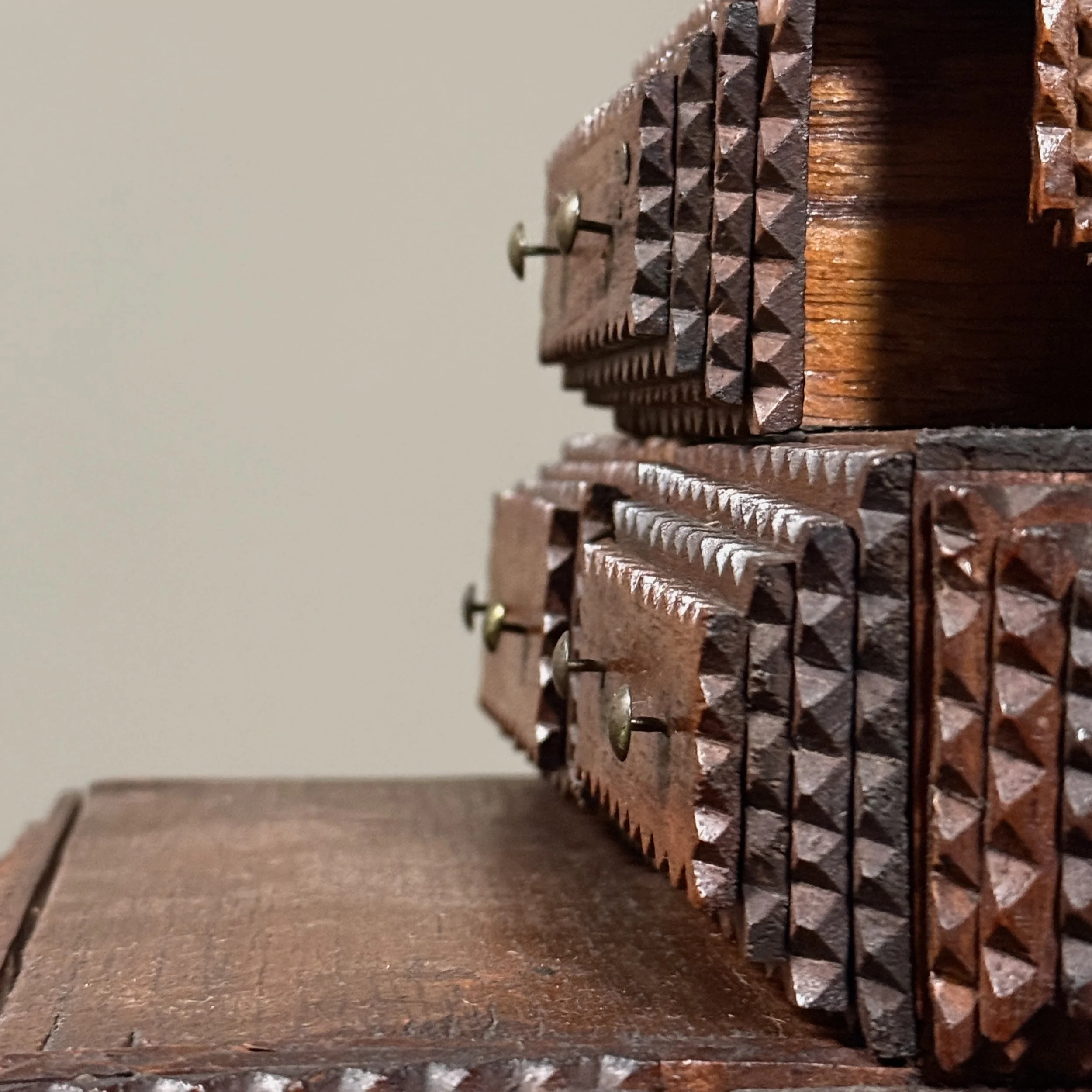 Detail of the chip-carved and layered wooden surface.