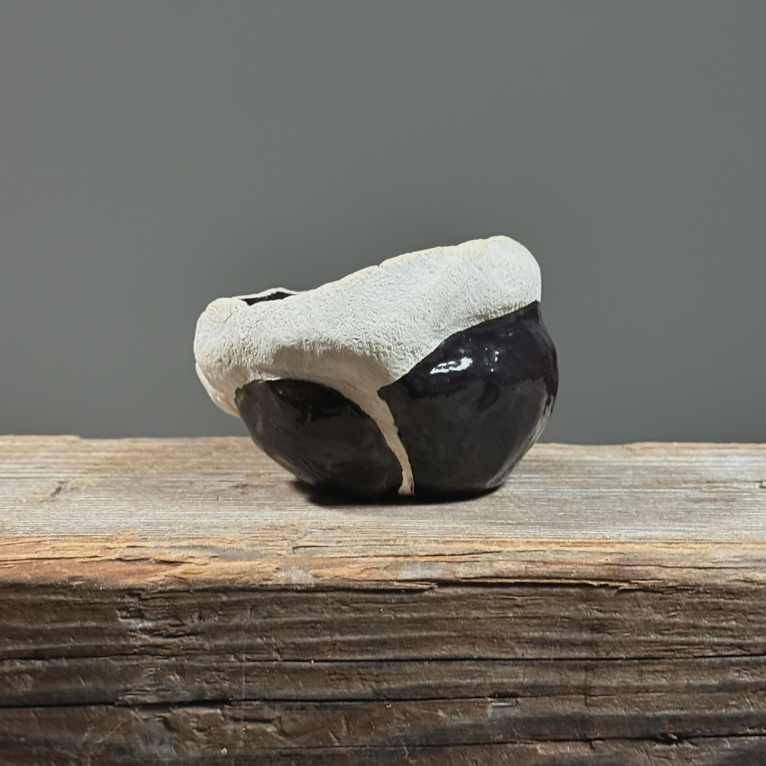 Glossy black vessel. Smooth finish. Modernist silhouette.