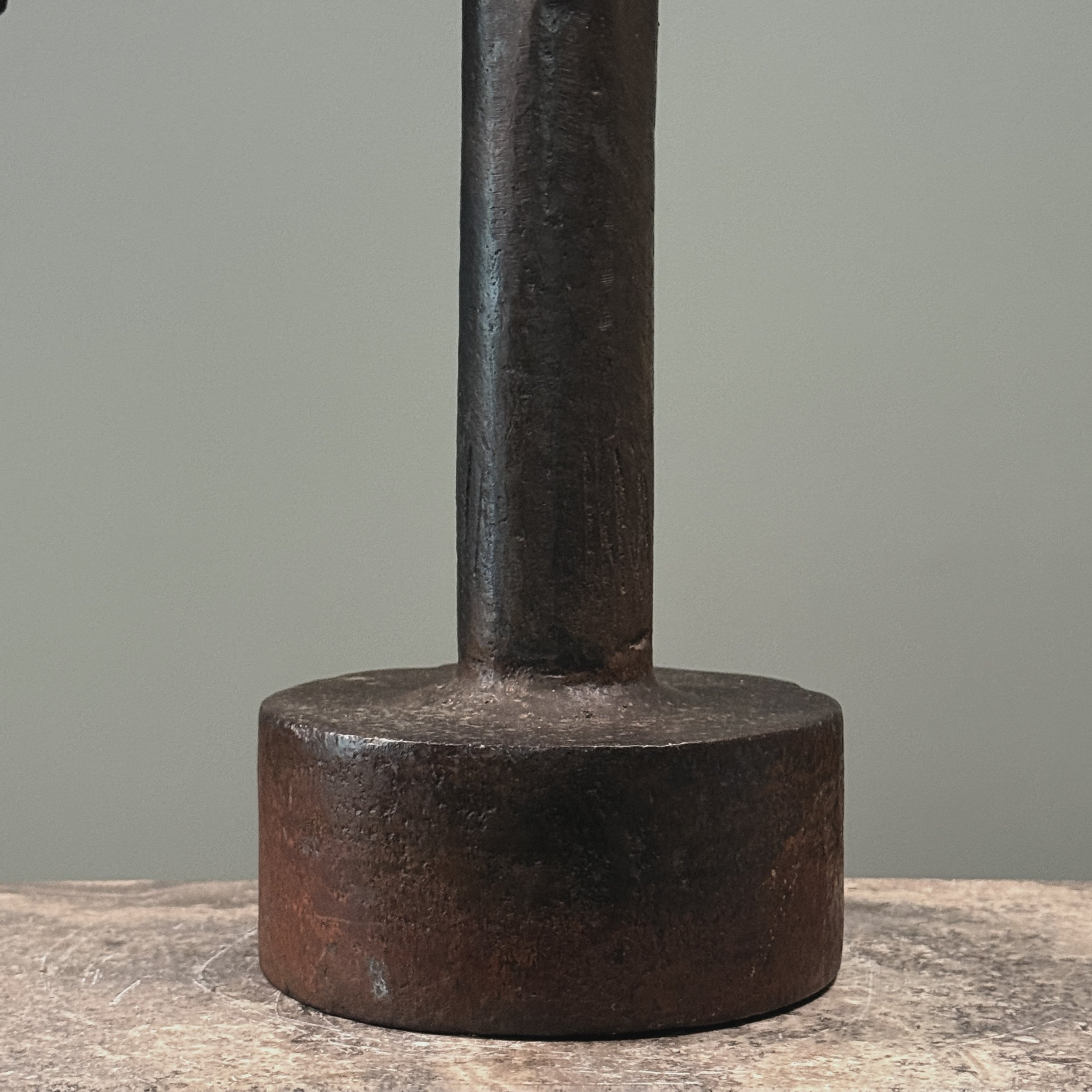 Close-up of forged iron elements. Raw material texture and industrial finish visible.