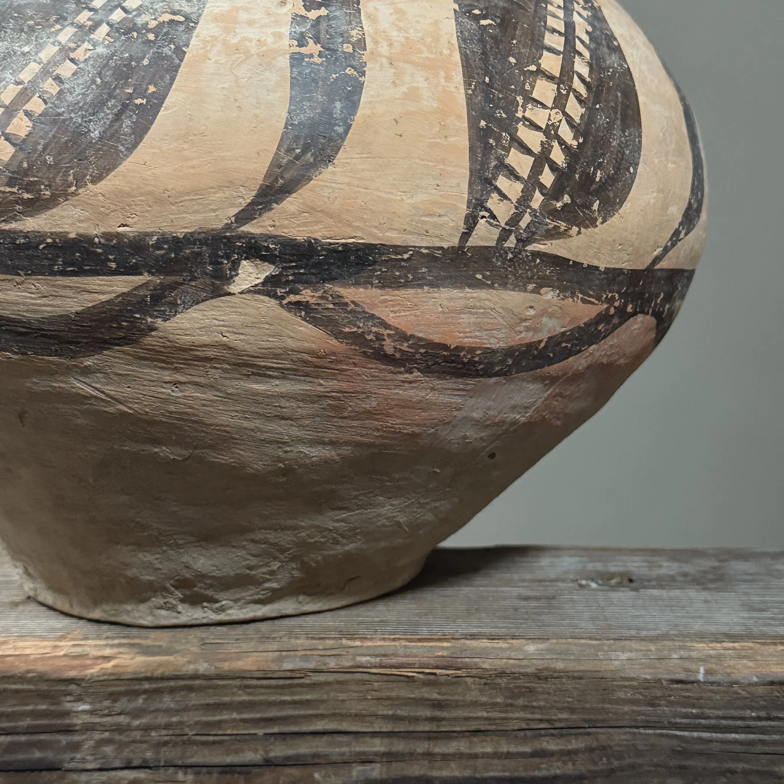 Close-up detail of the black painted designs on the jar.