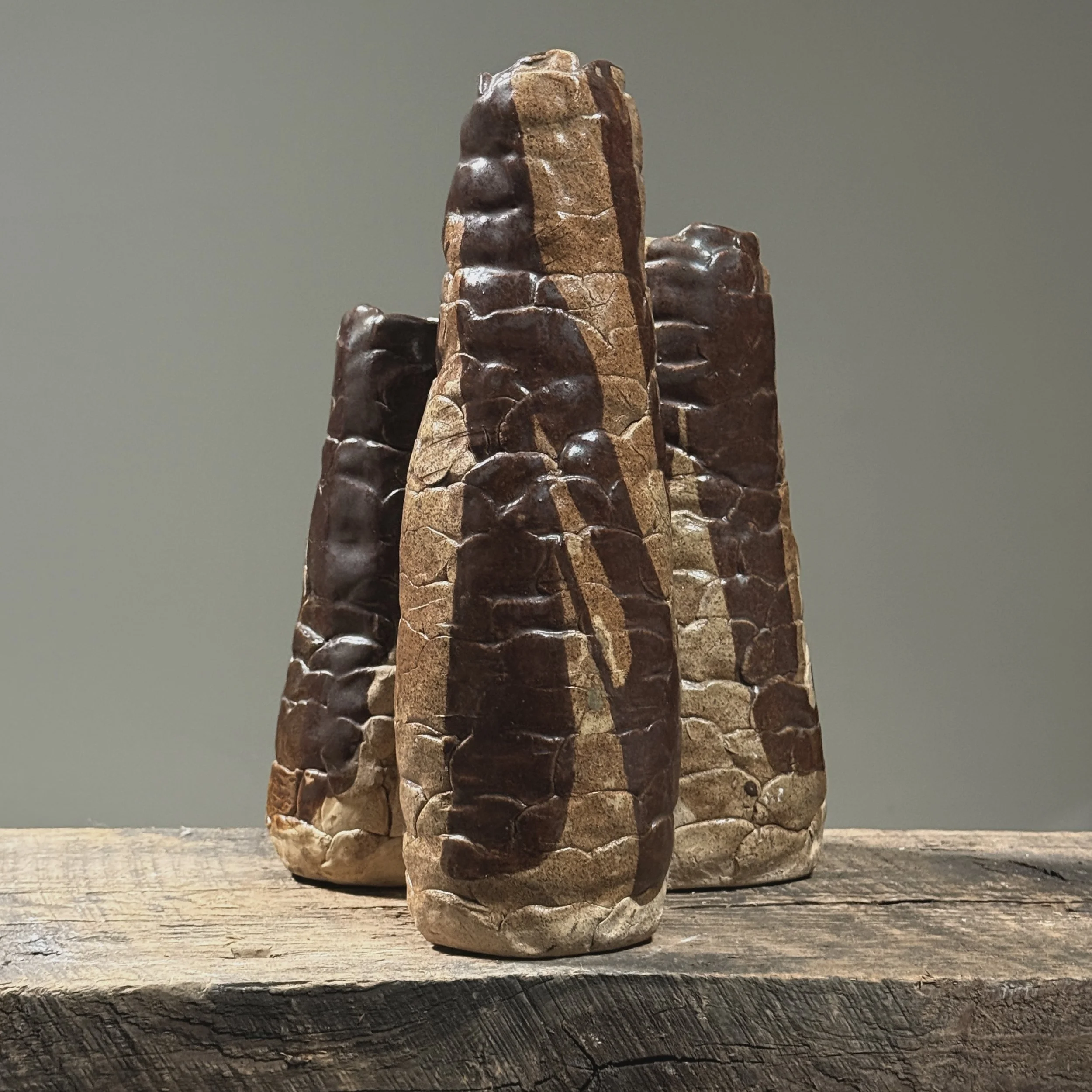 Full frontal view of a vintage Brutalist hand-built ceramic vessel with three connected cylindrical forms