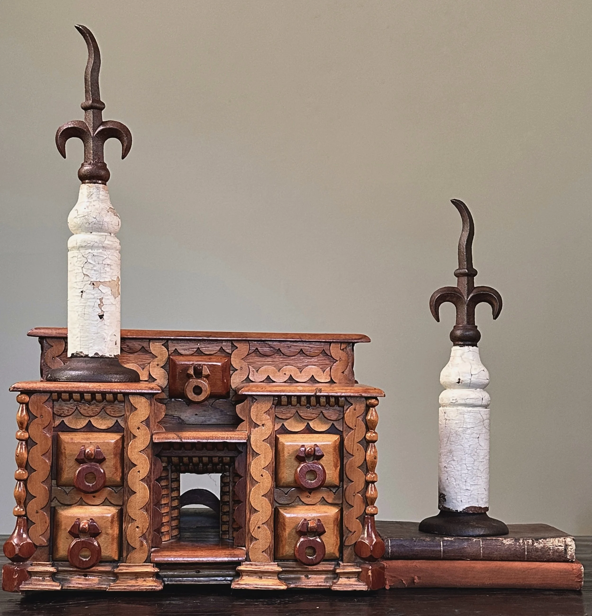 Pair of antique French fleur-de-lis cast iron finials on patinated wood bases