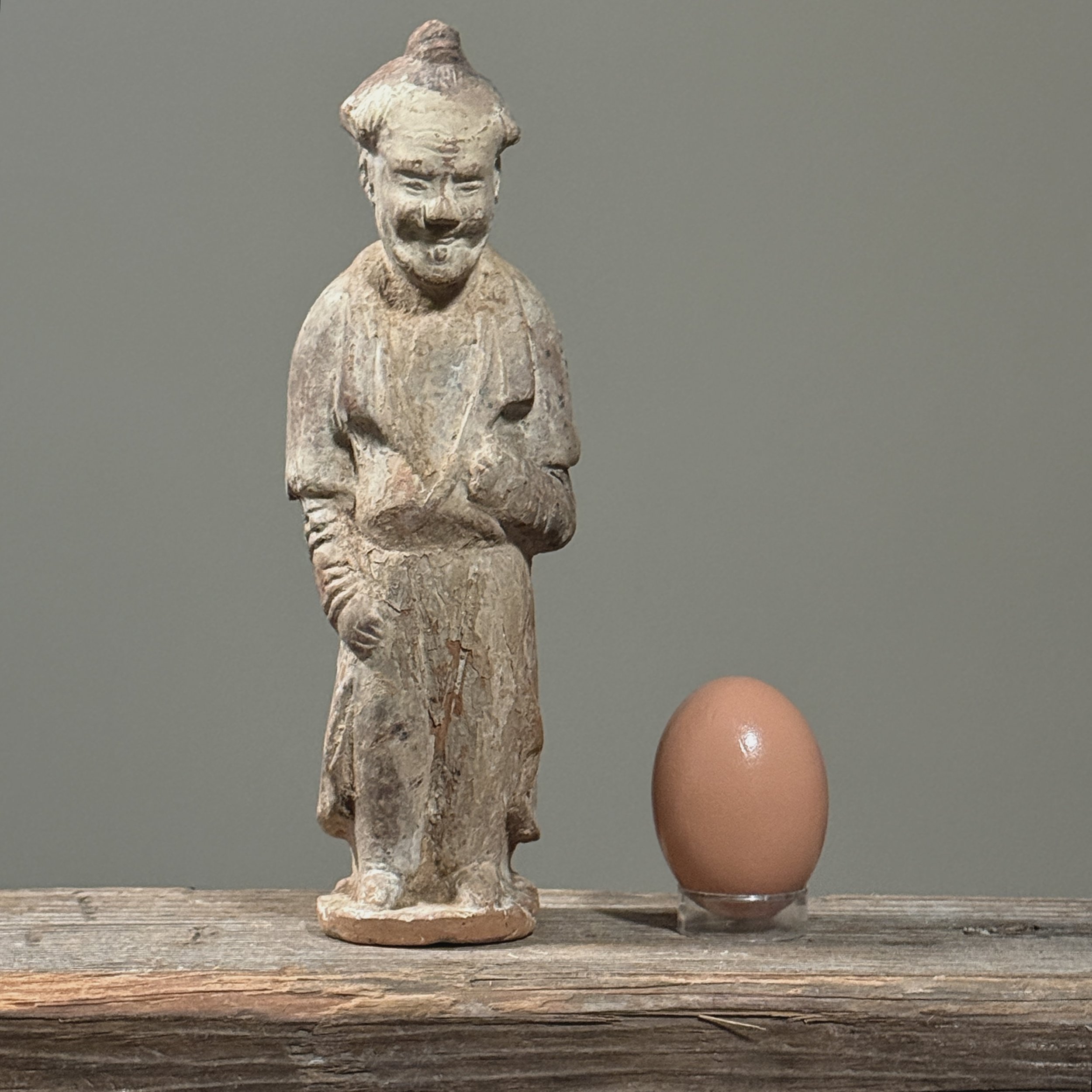 Scale presentation with the tomb attendant figure adjacent to an egg.