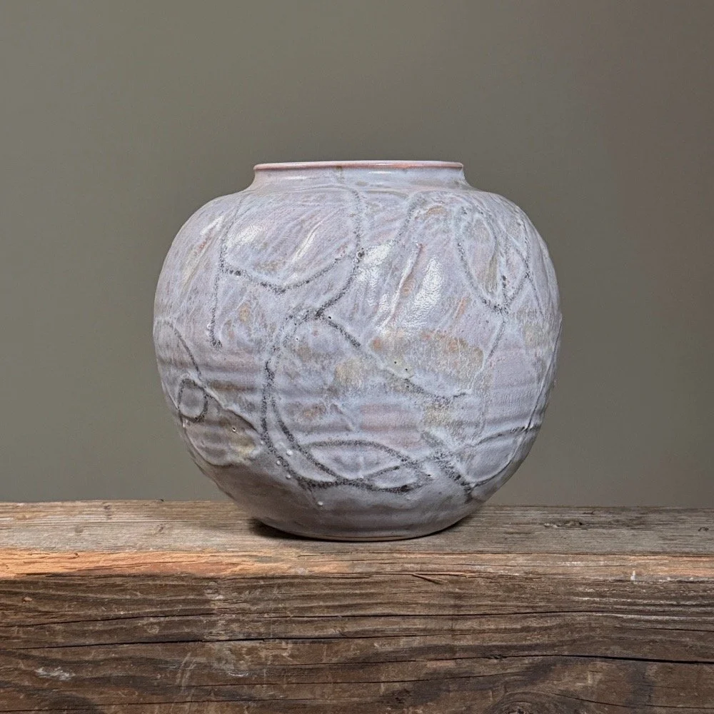 Front view of a vintage Japanese ceramic vase with light purple glaze.