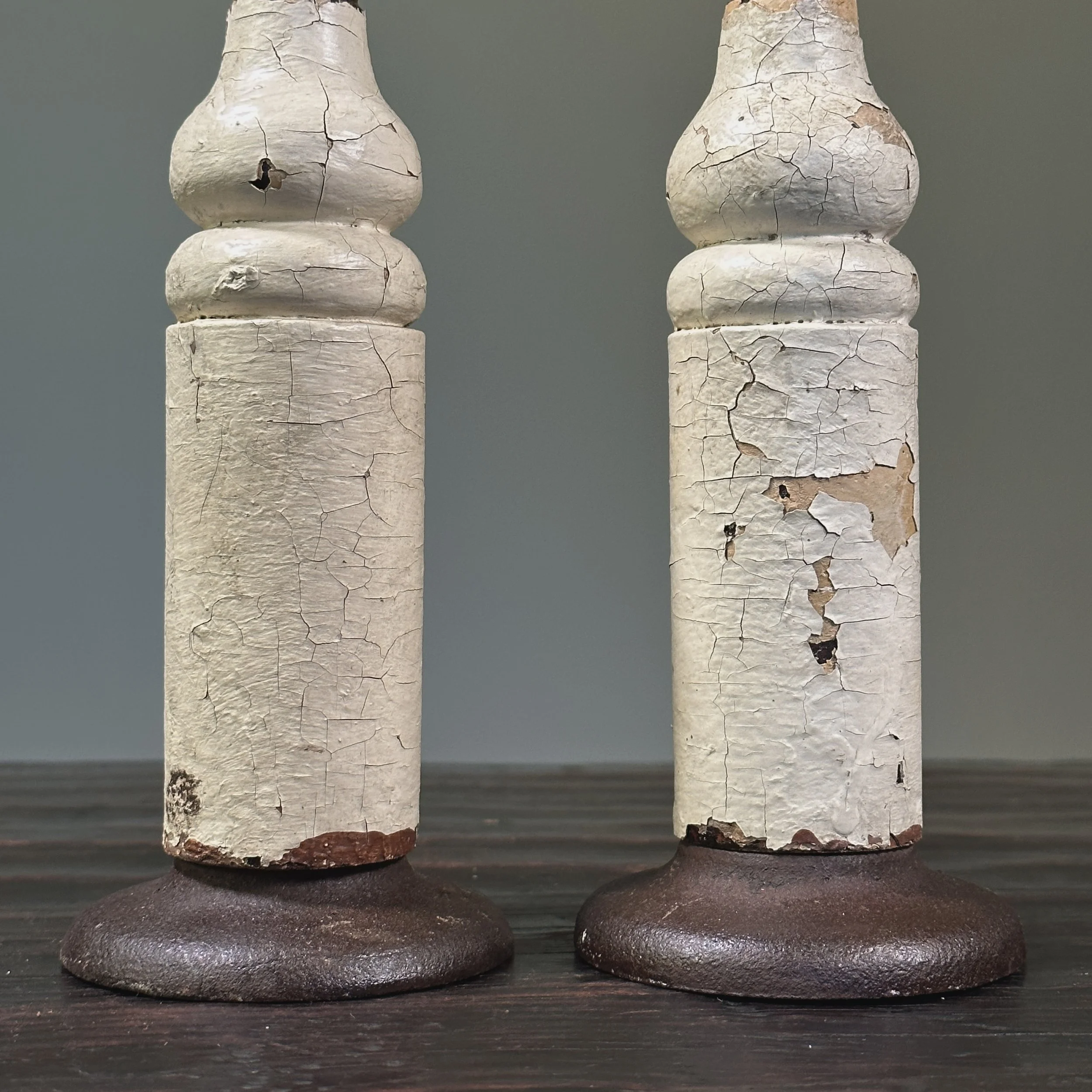 Pair of antique French fleur-de-lis cast iron finials on patinated wood bases