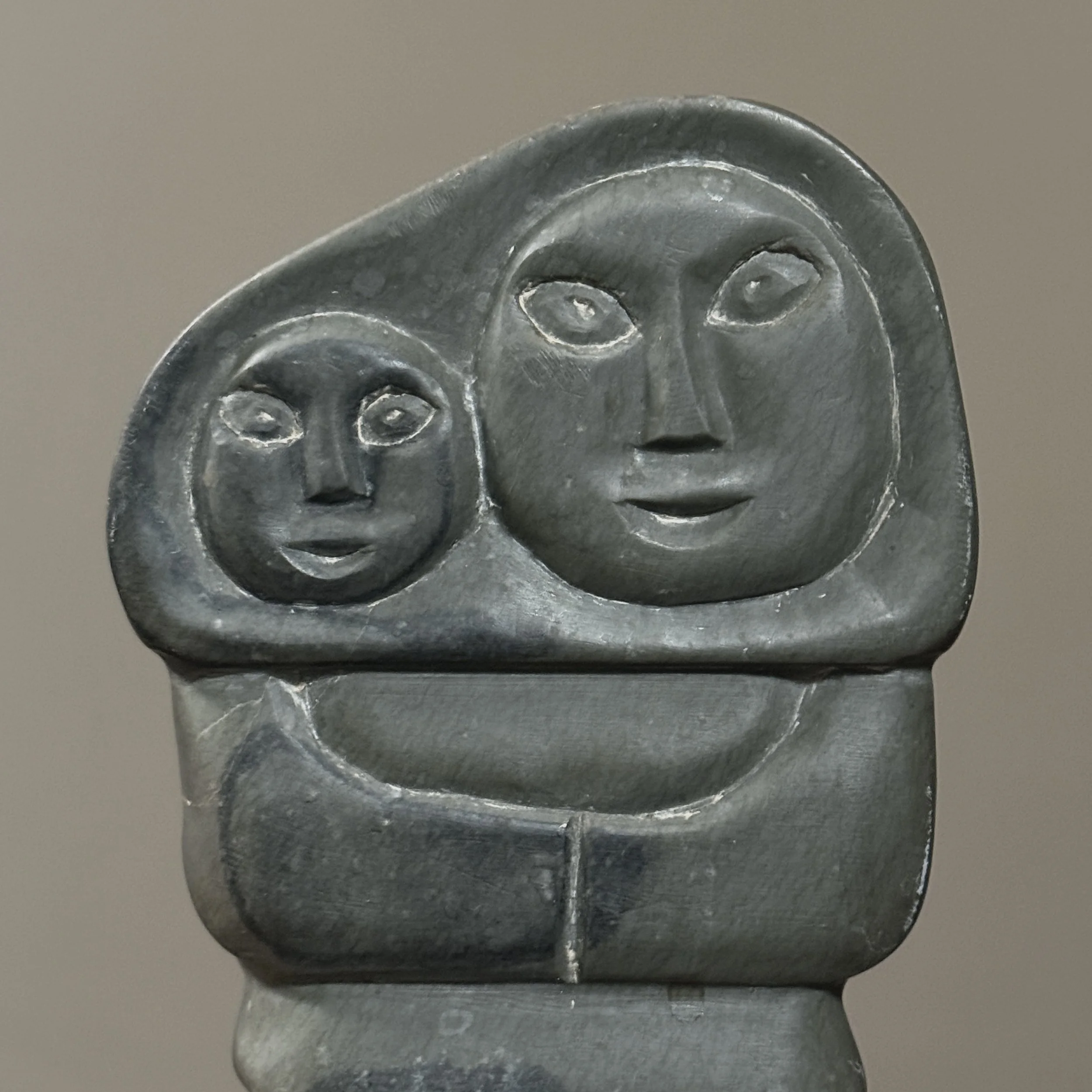 Detail of mother and child forms in Inuit stone carving