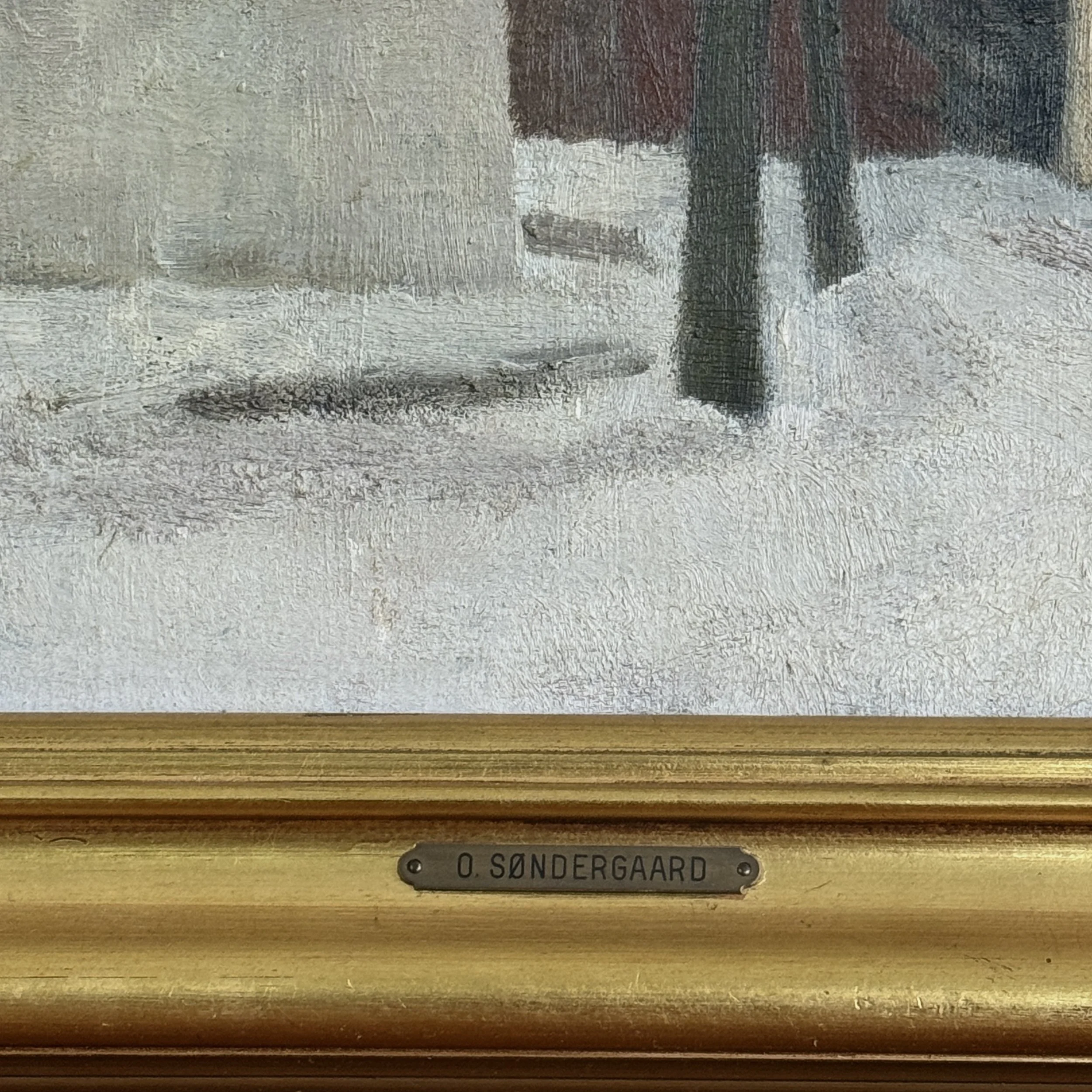 Close-up of original nameplate on lower edge of frame of Ole Søndergaard winter landscape painting