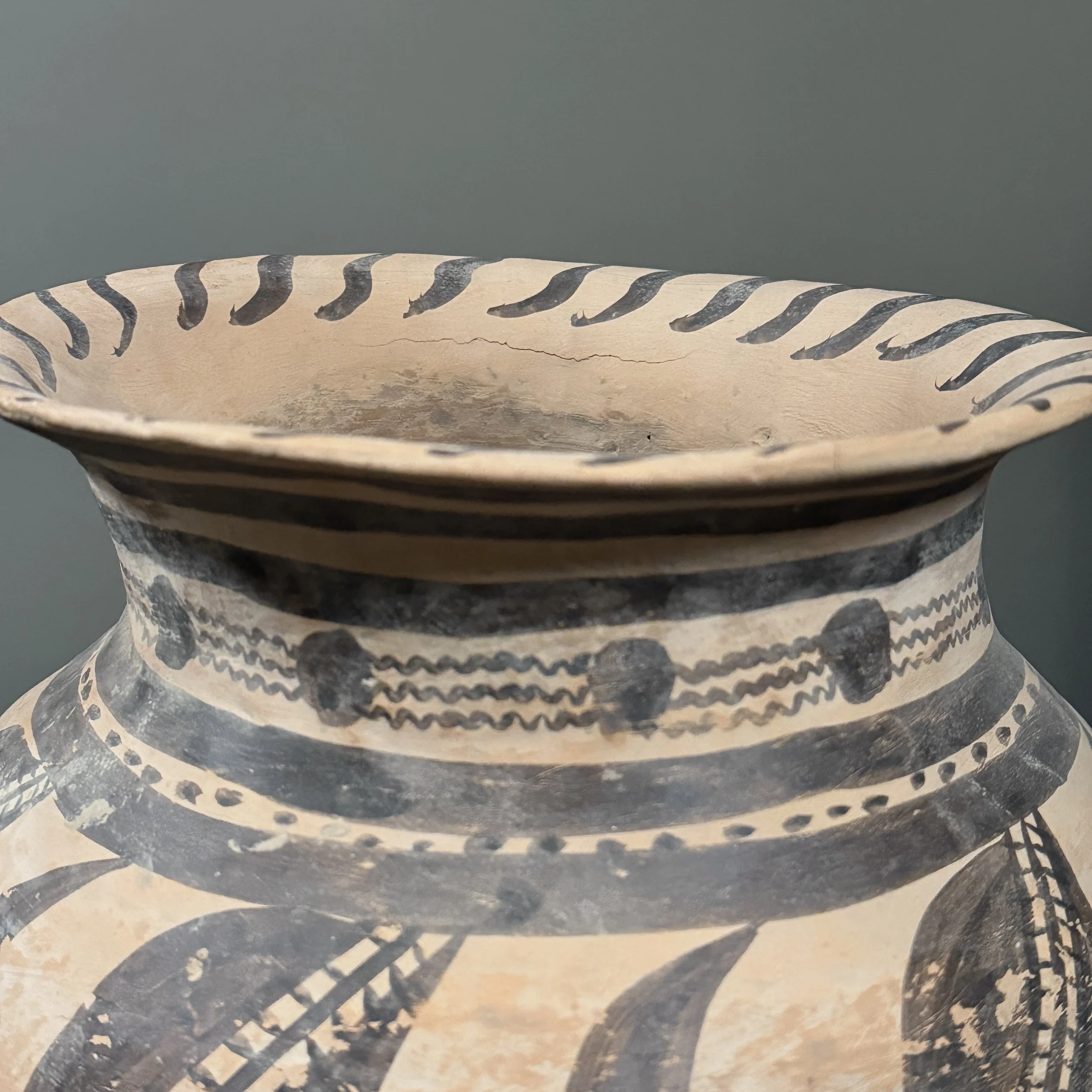 View of the vessel's flared rim and small age-related crack.