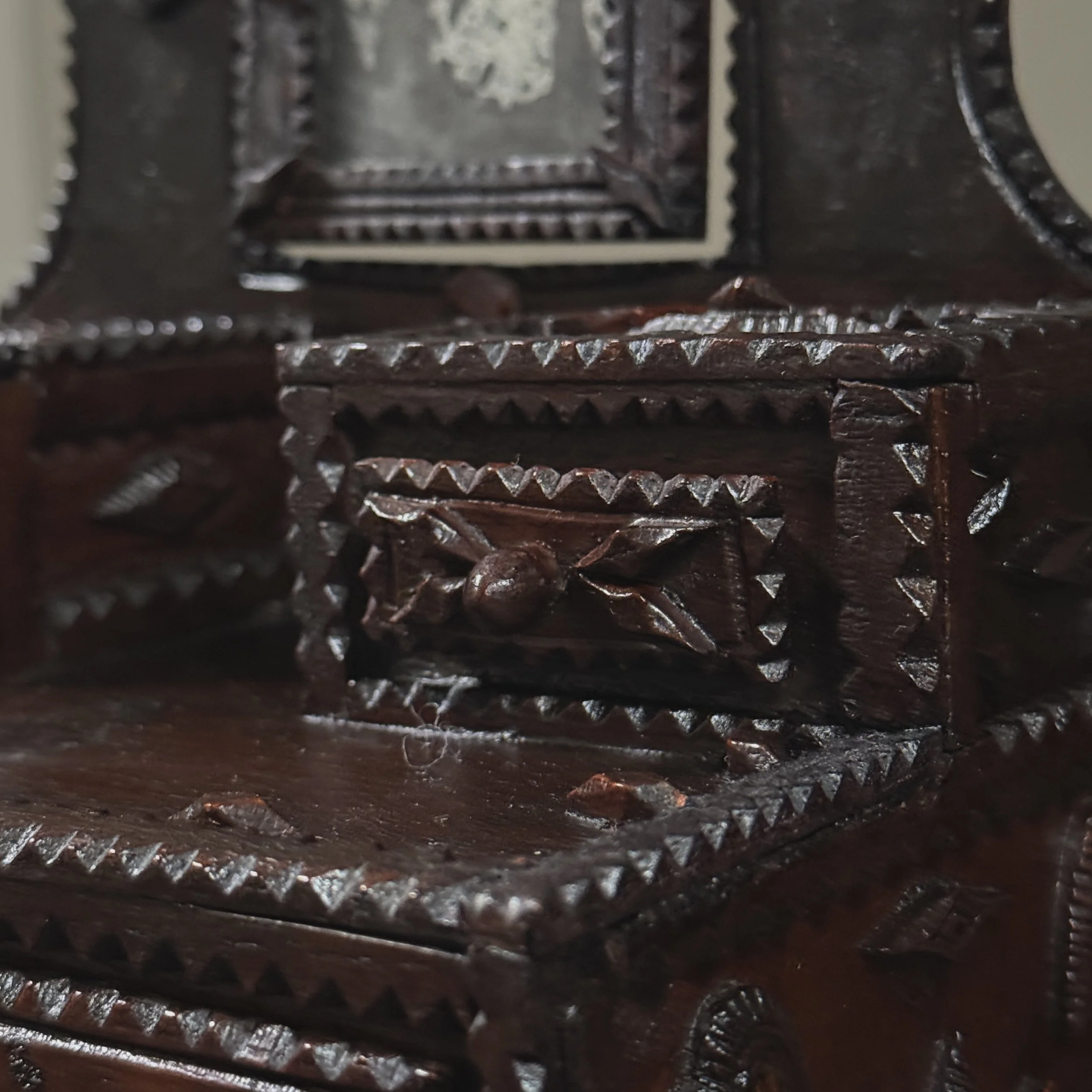 Angled view of dresser emphasizing depth and dimensional carving