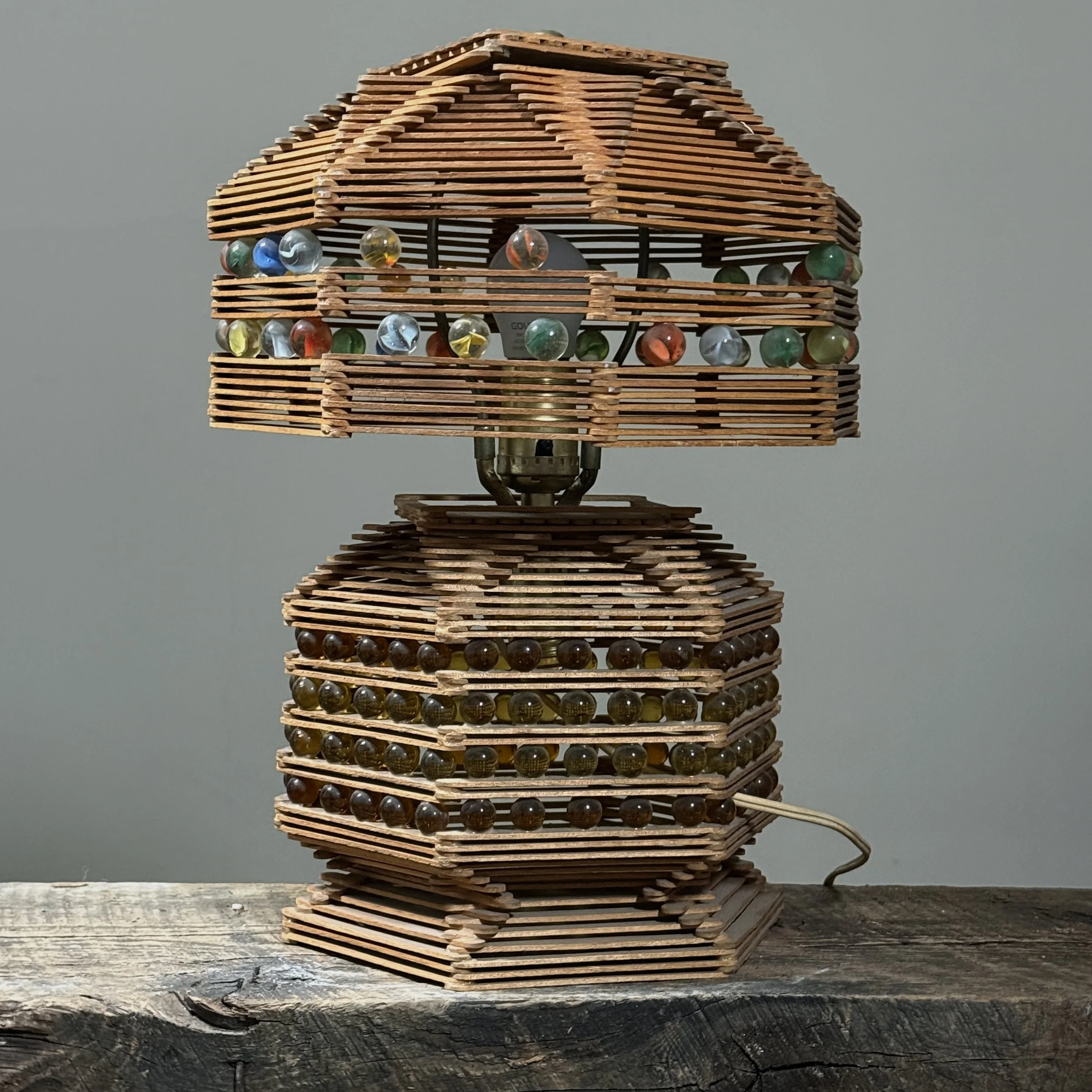 Rear angle of the lamp, clearly showing the areas with missing marbles on the shade.