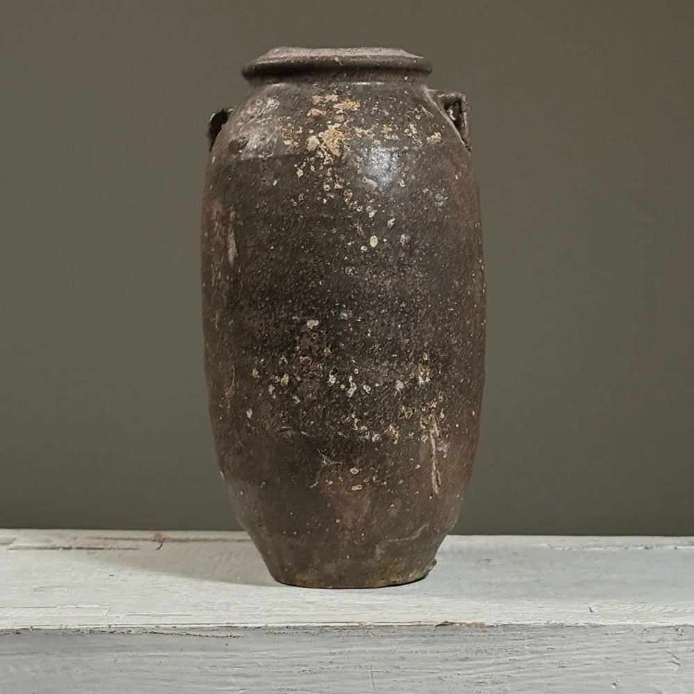 Full view of a 17th-century Vietnamese brown-glazed stoneware jar with lug handles.