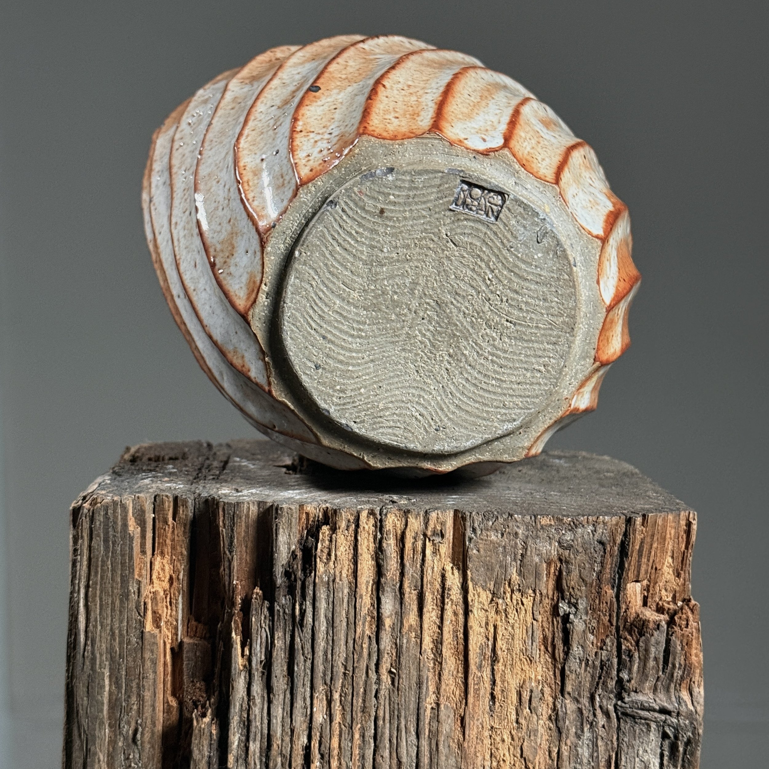 View of the base showing the artist's signature.