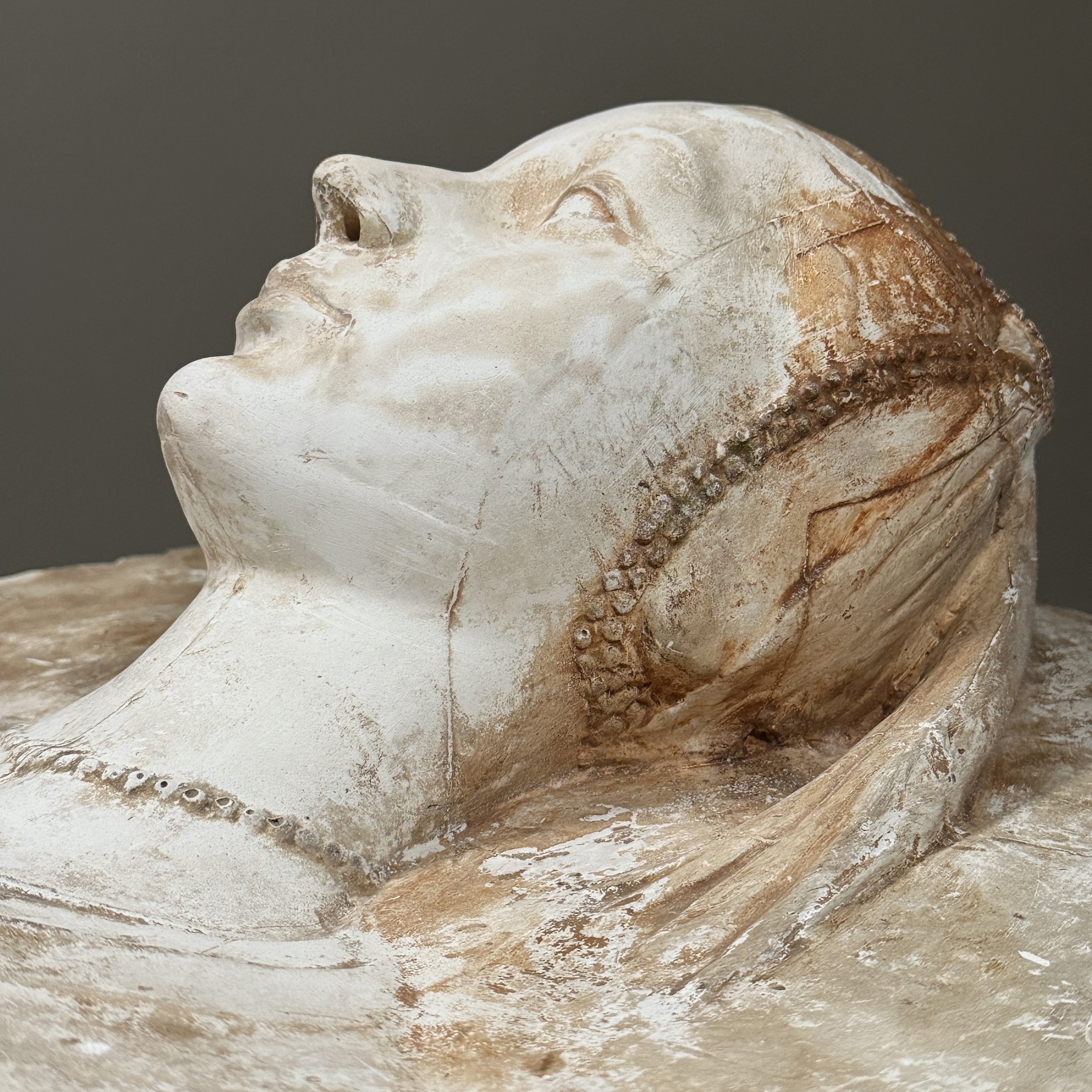 Profile view of the sculptural relief.